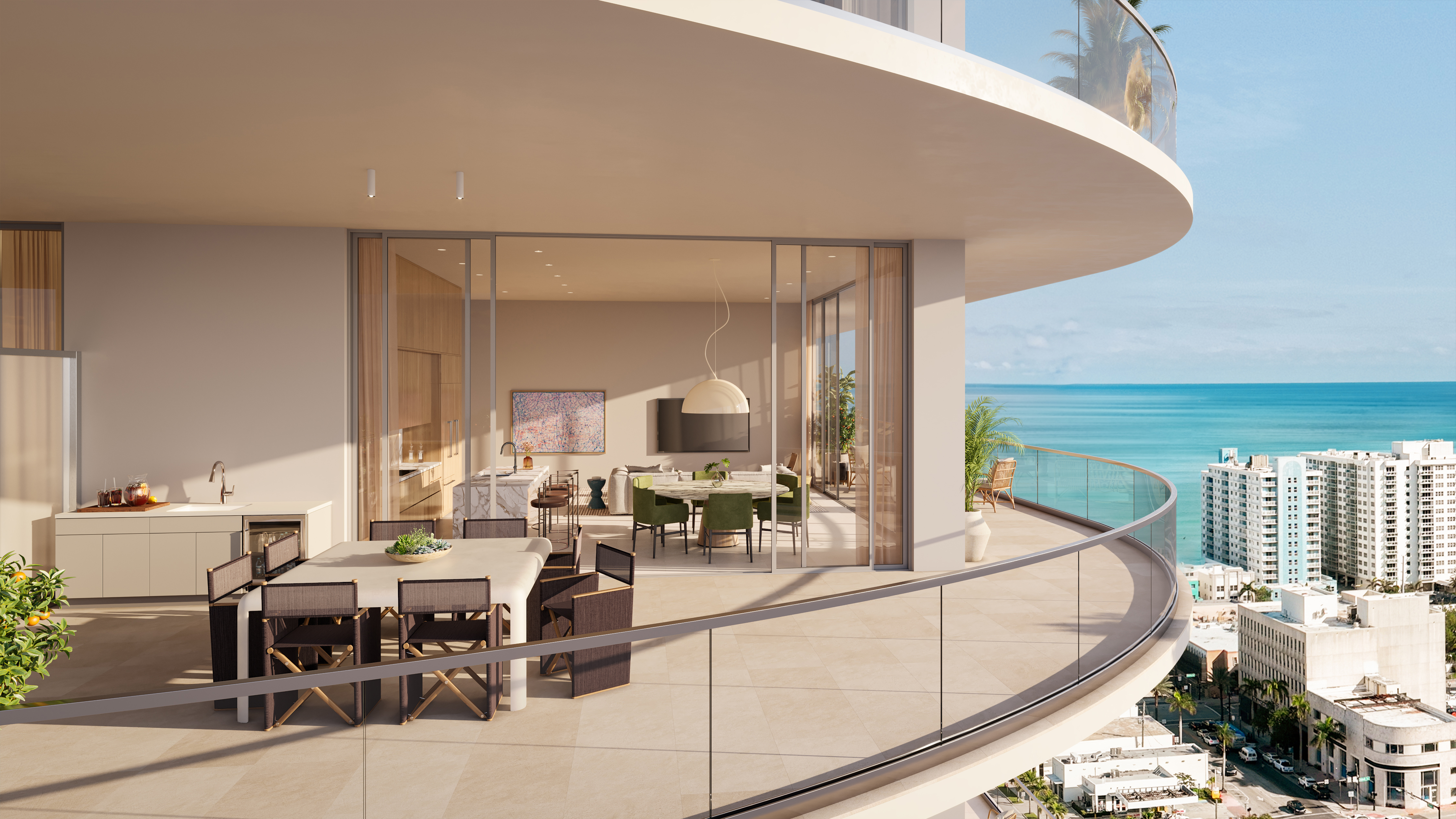 This image showcases a luxurious balcony with an outdoor dining area, seamlessly connected to the interior living space through large sliding glass doors. The balcony features a modern dining table with director's chairs, a built-in outdoor kitchen area, and a curved glass railing offering stunning ocean and city views. The overall impression is one of sophisticated outdoor living and elegant design.