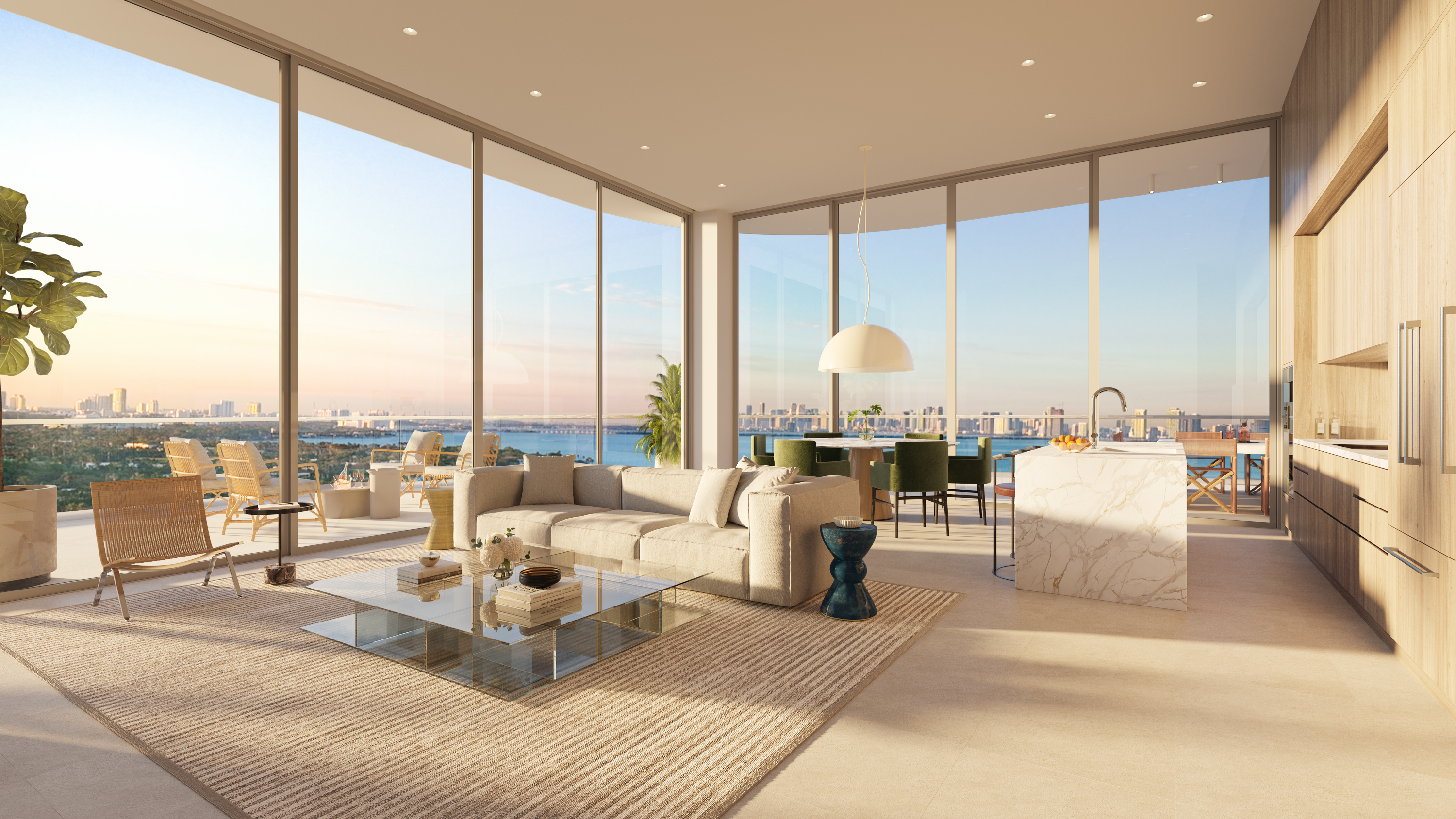This is a spacious and luxurious living area with floor-to-ceiling windows offering panoramic views of the city and water. The room features a neutral color palette, a large sectional sofa, a glass coffee table, and a modern kitchen with a marble island. The overall impression is one of elegance and sophistication, perfect for upscale living.