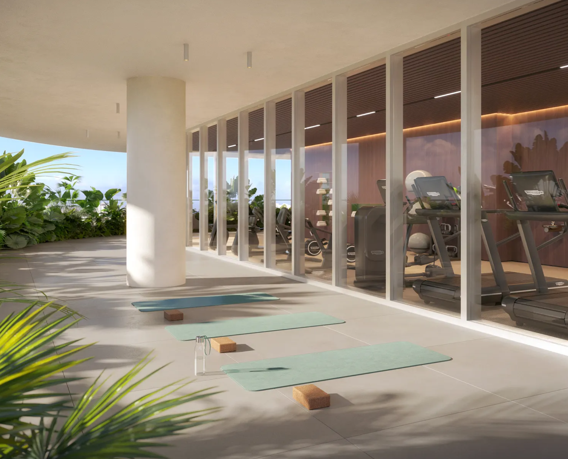 This image showcases a community amenity featuring a home gym. Yoga mats and blocks on the outdoor portion suggest a flexible space for physical activities. Clean, modern design with plentiful greenery enhances this health-focused amenity.