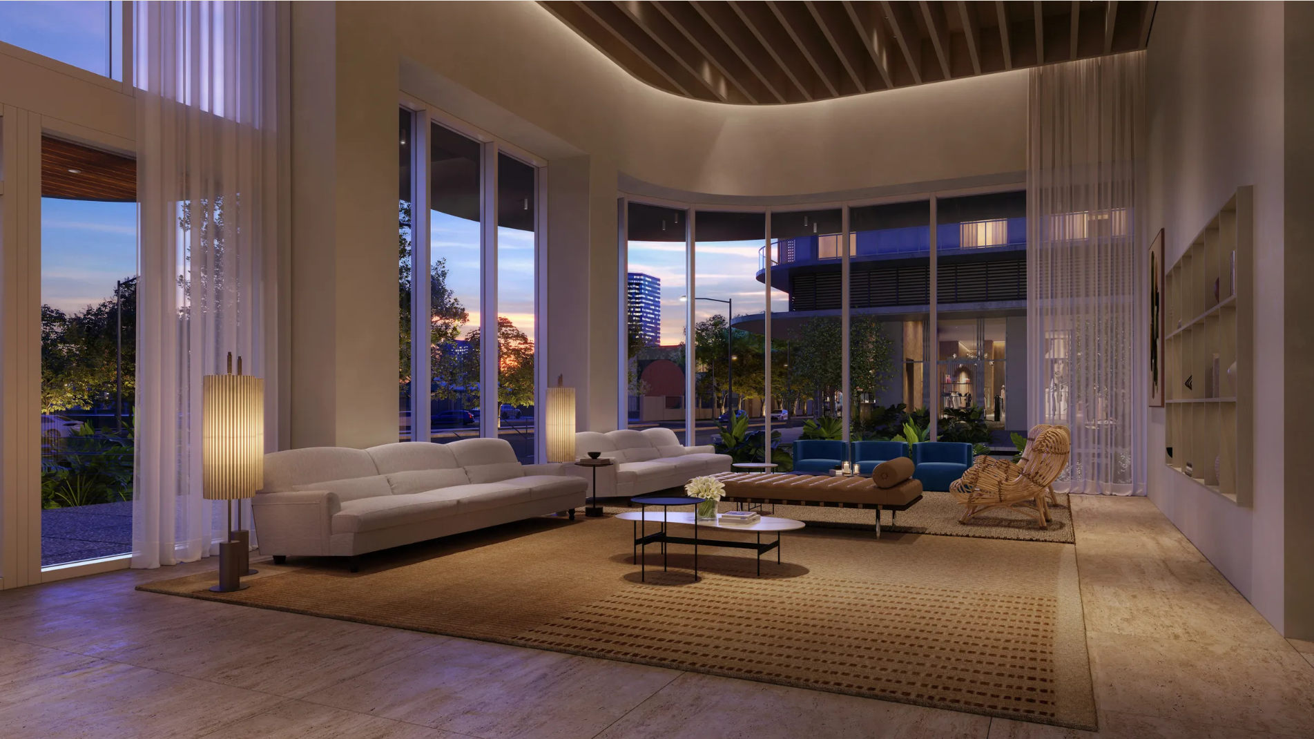 This is an inviting living room featuring modern sofas, a coffee table, and stylish lighting fixtures. Large windows provide ample natural light and views of the outdoors. The overall design creates a sophisticated and comfortable living space, perfect for relaxation and entertaining.