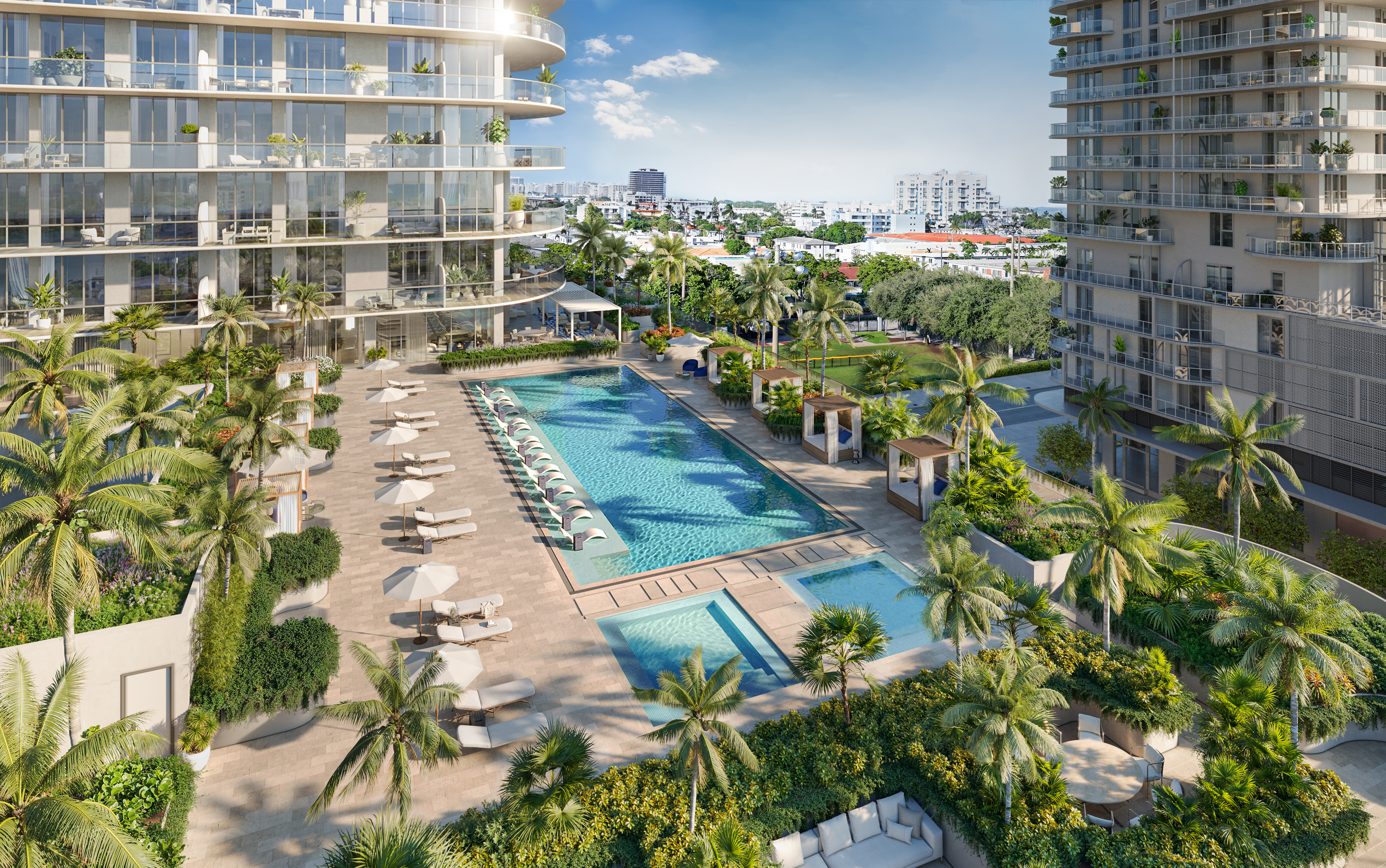 This aerial view showcases a luxurious pool and spa area nestled between modern high-rise buildings. The pool is surrounded by lounge chairs and umbrellas, with lush landscaping and cabanas adding to the resort-like atmosphere. The scene evokes a sense of relaxation and upscale living.