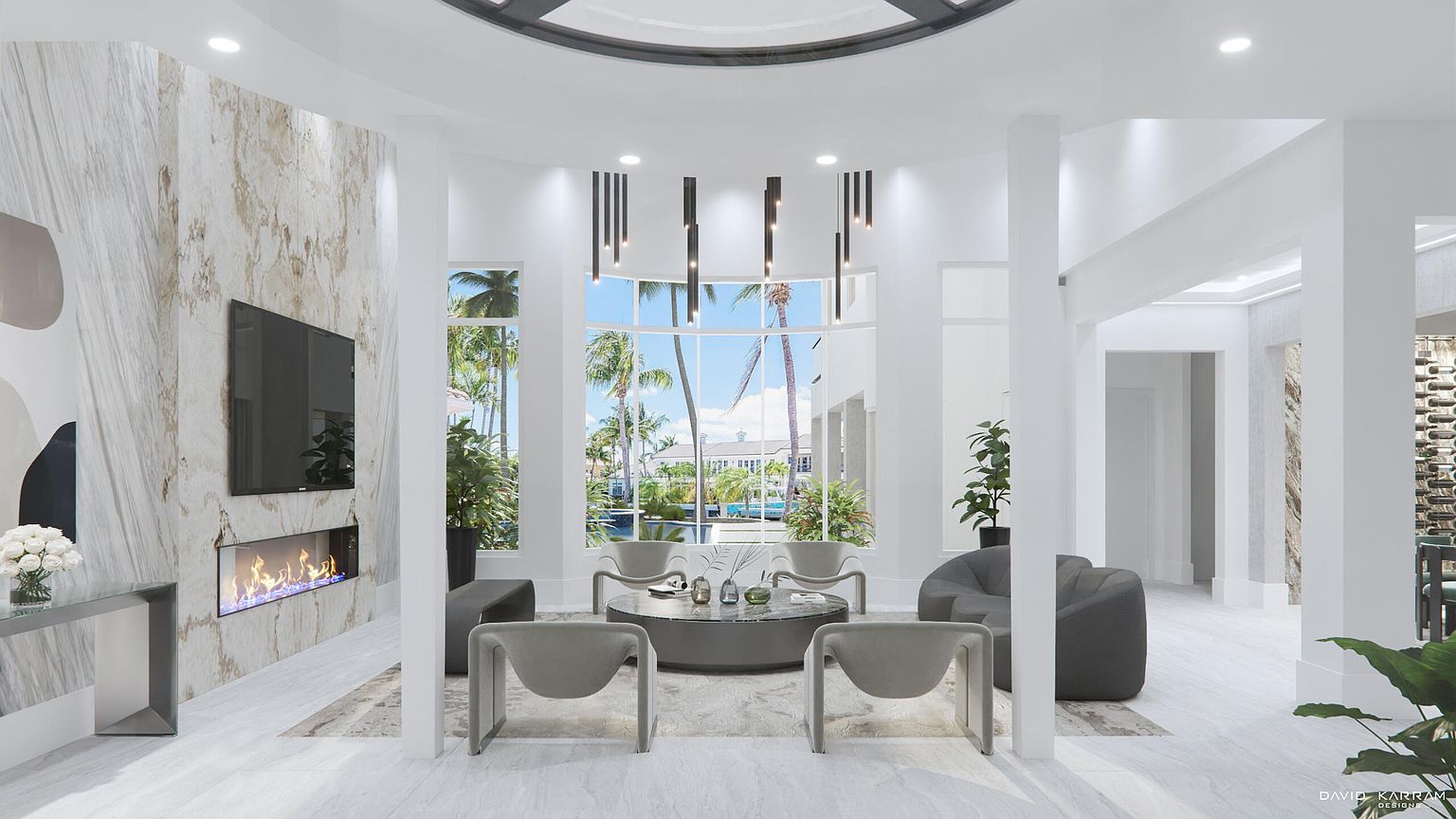 This is an interior shot of a modern living room featuring a curved wall with a large window offering a view of palm trees and a building with a pool. The room is furnished with contemporary gray chairs and a round coffee table, complemented by a sleek fireplace and a wall-mounted television. The overall aesthetic is bright, airy, and luxurious, creating a welcoming and sophisticated atmosphere.