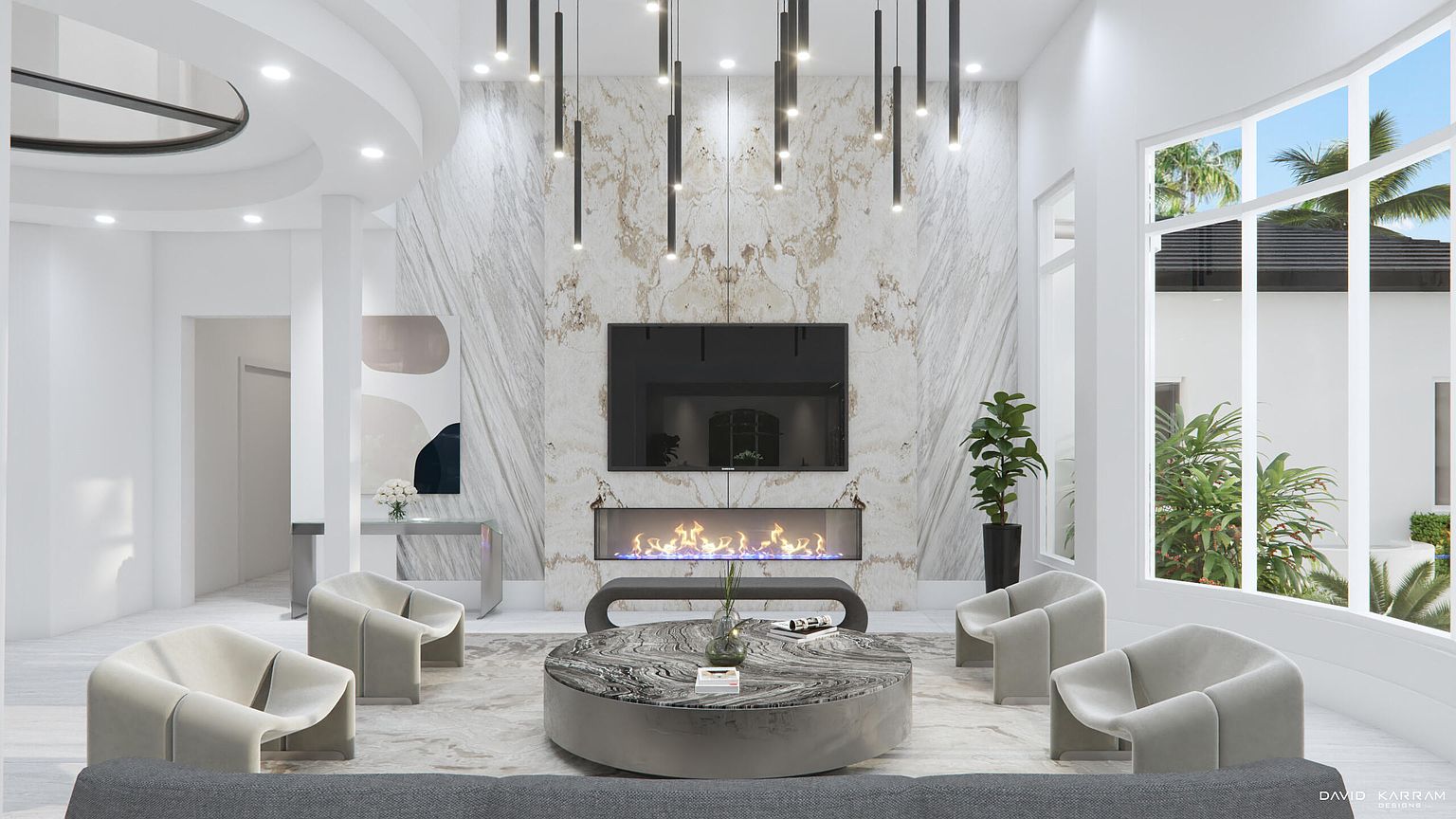 This is a luxurious living room featuring a modern fireplace with a TV mounted above it, surrounded by a marble accent wall. The room is furnished with contemporary chairs and a unique round coffee table, all set on a patterned rug. Large windows provide ample natural light, enhancing the bright and airy atmosphere.