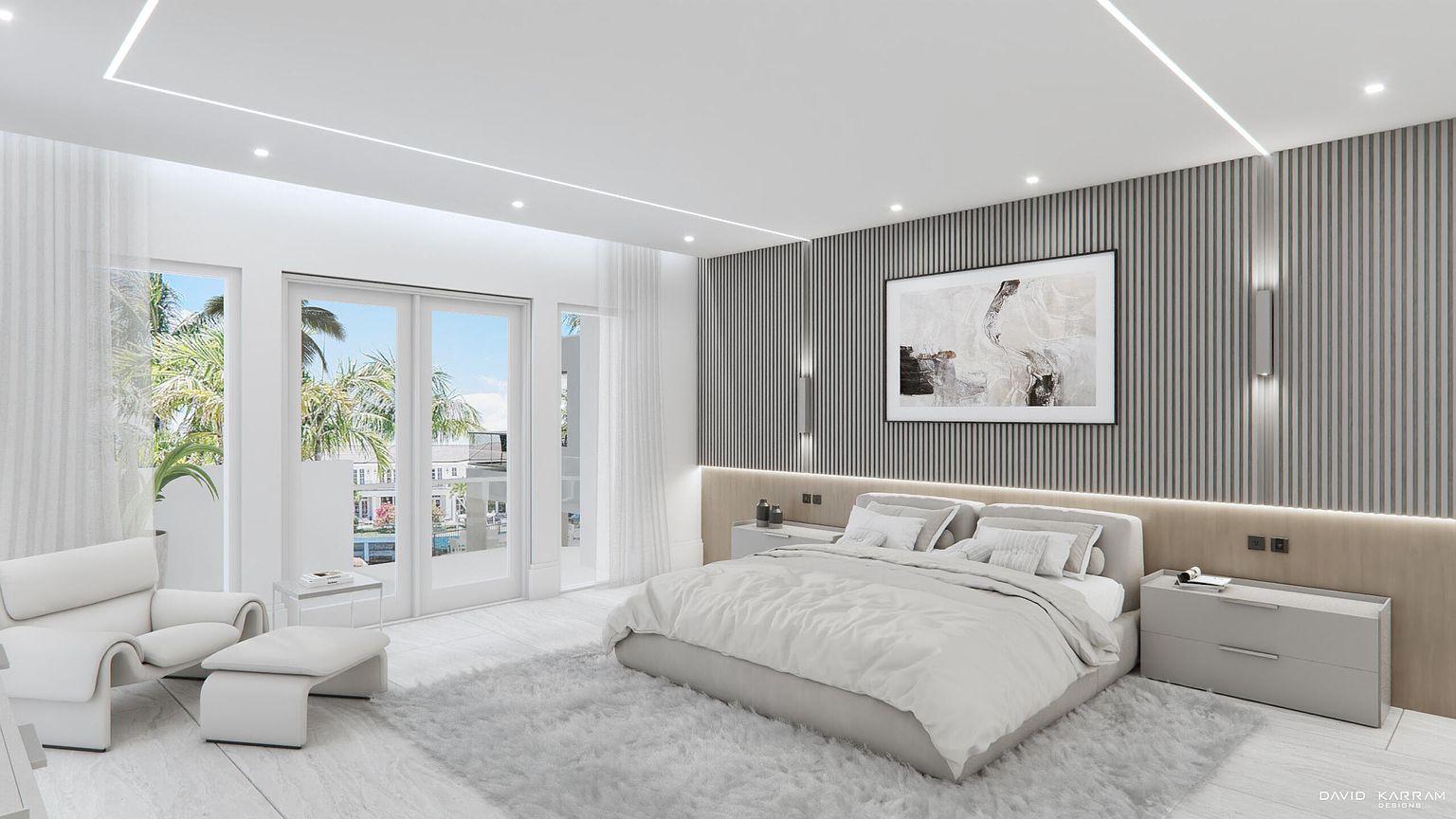This is a bright and modern primary bedroom featuring a large bed with white linens, a gray accent wall with vertical paneling, and contemporary artwork. The room has access to a balcony through sliding glass doors, offering plenty of natural light and a view of palm trees. The overall design is minimalist and luxurious, creating a serene and inviting atmosphere.