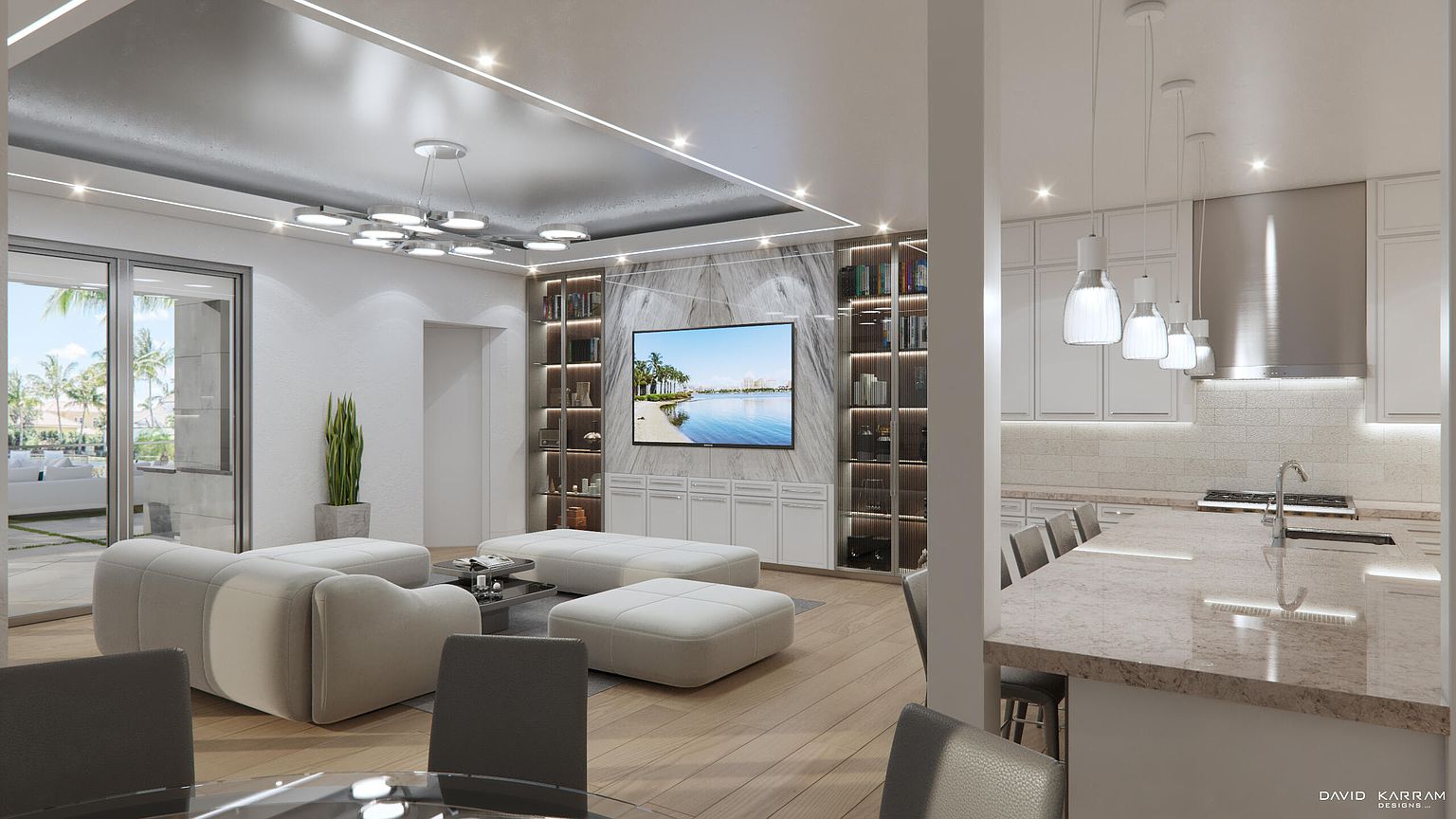 This interior shot showcases a modern living room seamlessly connected to a contemporary kitchen. The living area features a plush, modular sofa arrangement facing a large television mounted above sleek white cabinetry, flanked by illuminated shelving units. The kitchen boasts a spacious island with bar seating and pendant lighting, creating an open and inviting atmosphere perfect for entertaining.