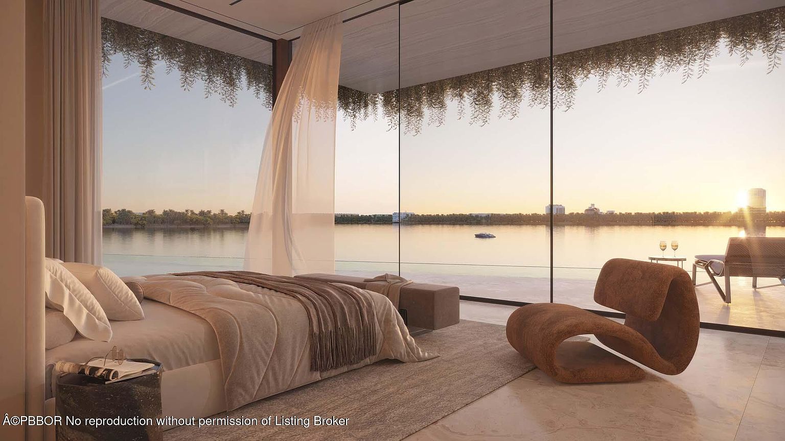 This is a luxurious primary bedroom with floor-to-ceiling windows offering a stunning waterfront view at sunset. The room features a neutral color palette, a plush bed with a cozy throw, and a modern sculptural chair. The overall impression is one of tranquility and high-end comfort.