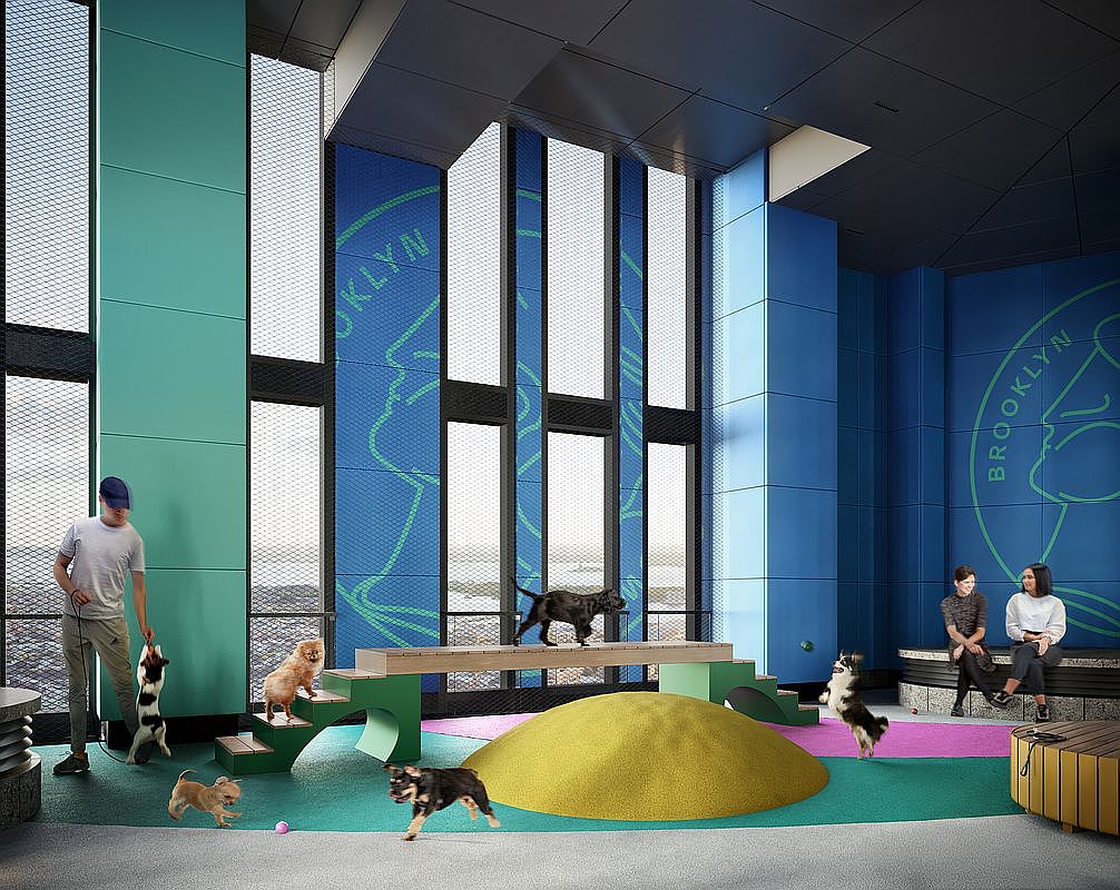 This vibrant, modern indoor dog park features colorful, pet-friendly play equipment, including a ramp, a yellow mound, and a spacious, open-concept design. Large floor-to-ceiling windows with 'Brooklyn' branding allow for natural light, creating an inviting and energetic atmosphere for residents and their pets. The space is designed with a contemporary aesthetic, combining functional play areas with comfortable seating for owners.