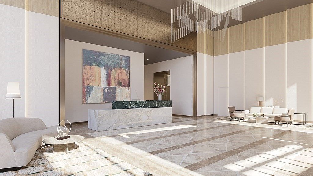 This grand, high-ceilinged lobby features a sophisticated reception area with a striking marble and dark stone desk, complemented by elegant contemporary furniture and a large abstract painting. The space is bathed in natural light, highlighting the polished stone flooring and intricate geometric wall paneling that creates a luxurious, welcoming atmosphere. The perspective is a wide-angle shot from the entrance, emphasizing the expansive scale and upscale design of the building's common area.