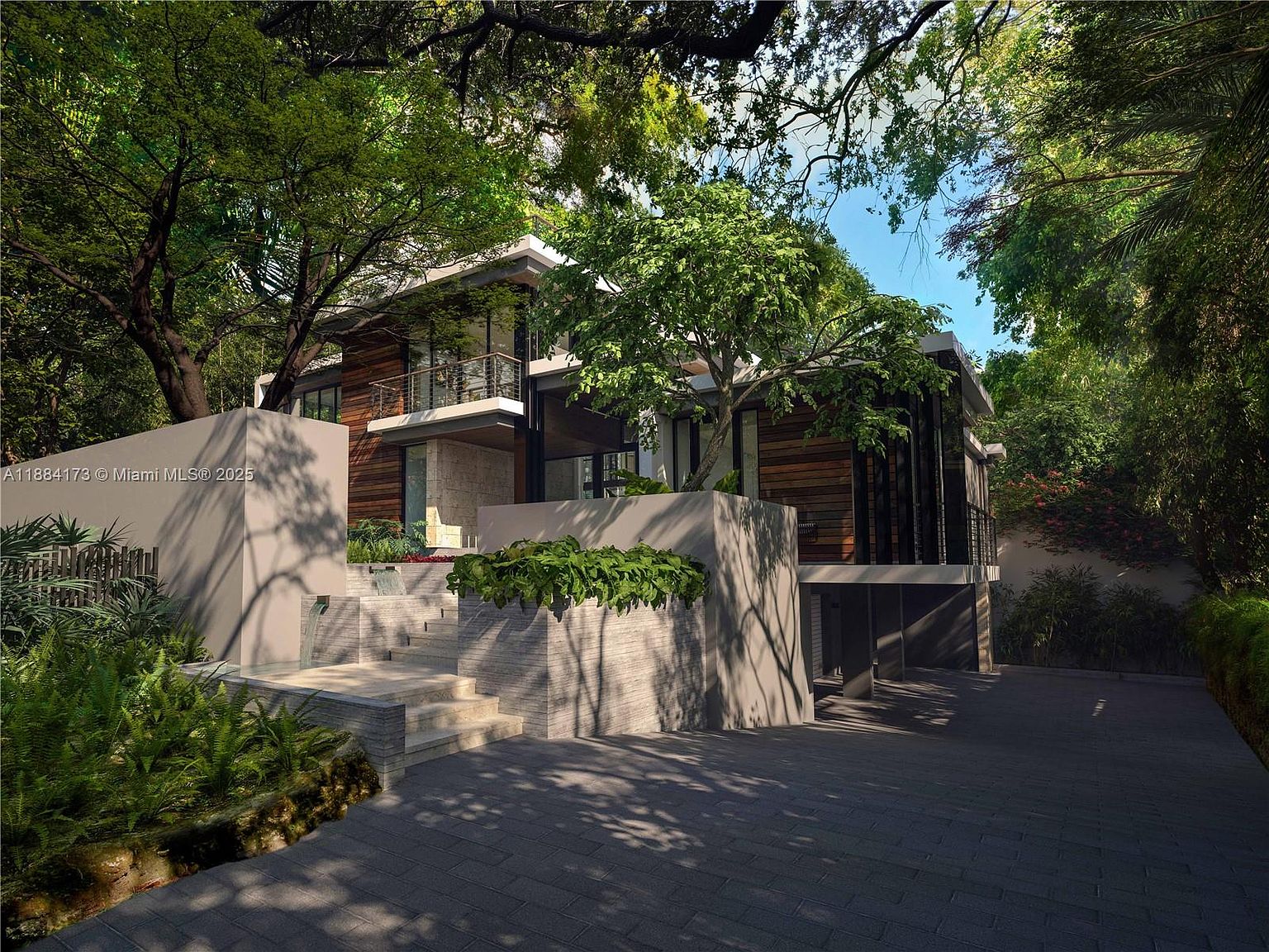 This is a front exterior view of a modern, multi-level home surrounded by lush greenery. The house features a combination of wood and stone facade, with large windows and balconies. A stone staircase leads to the entrance, and the driveway is paved with gray bricks, creating a sophisticated and inviting curb appeal.
