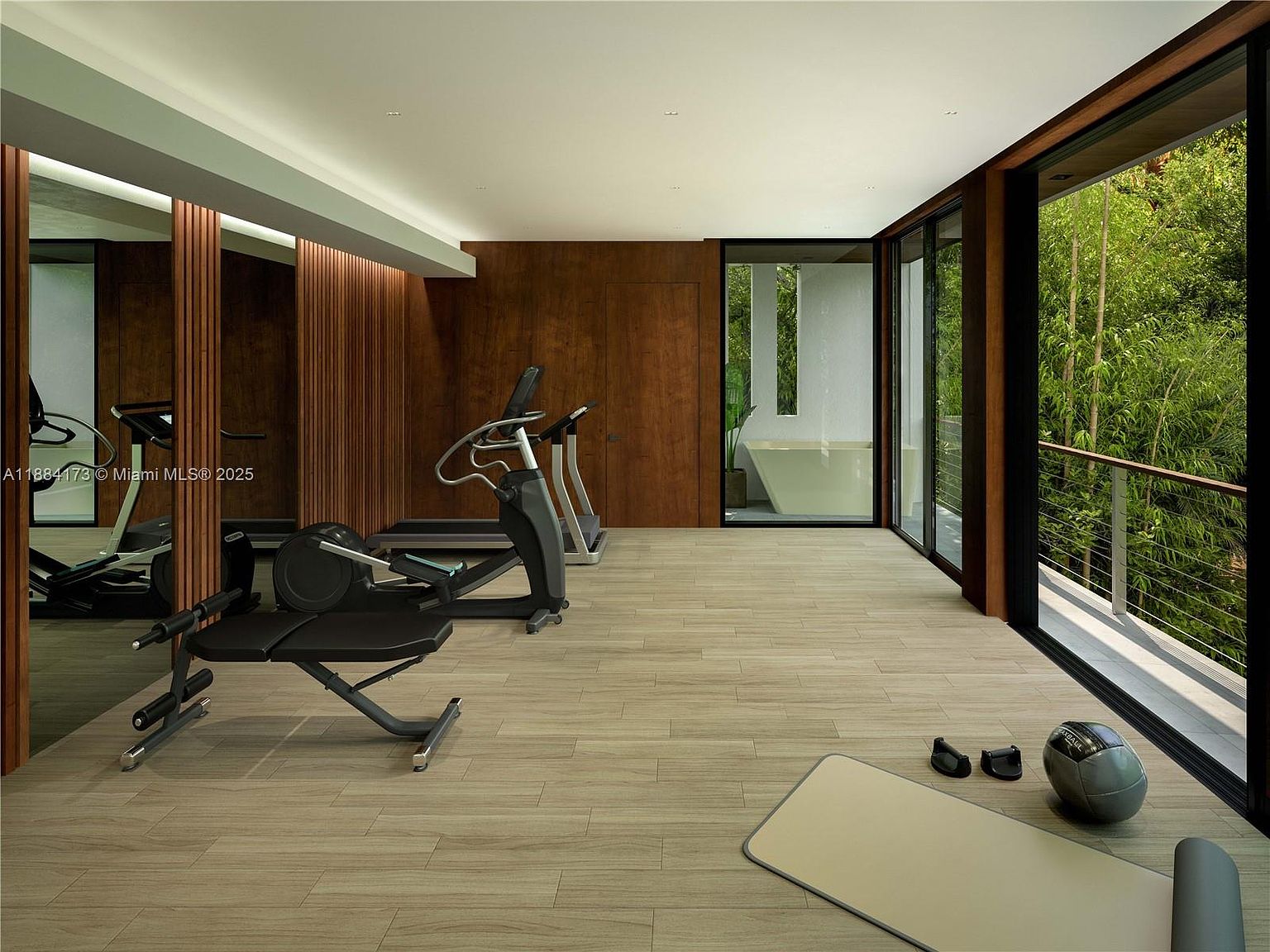 This is a modern home gym featuring wood-paneled walls and light wood flooring. The room is equipped with various exercise machines, including a treadmill and a weight bench. Large windows offer a view of lush greenery, creating a serene workout environment.