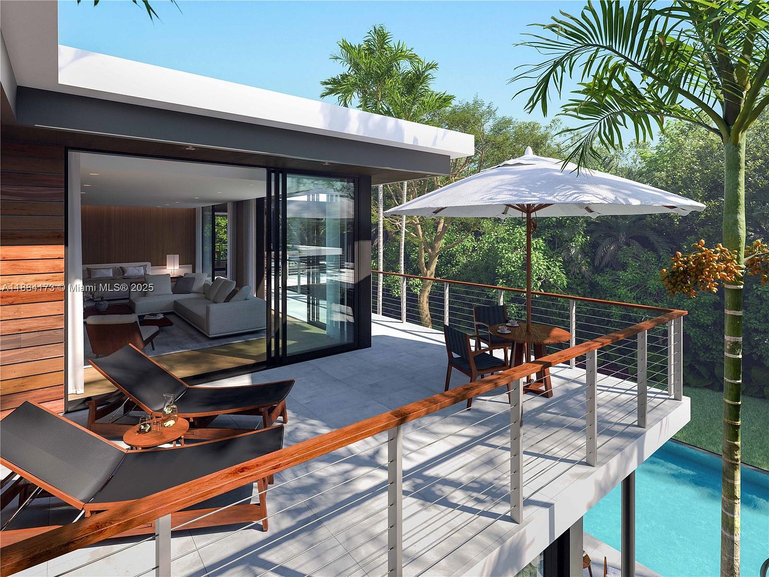 This image showcases a modern home's outdoor living space, featuring a spacious balcony with sleek lounge chairs and a dining area under a large umbrella. The balcony overlooks a pool and lush greenery, creating a serene and private atmosphere. The design emphasizes indoor-outdoor flow with large sliding glass doors connecting to the interior living space.