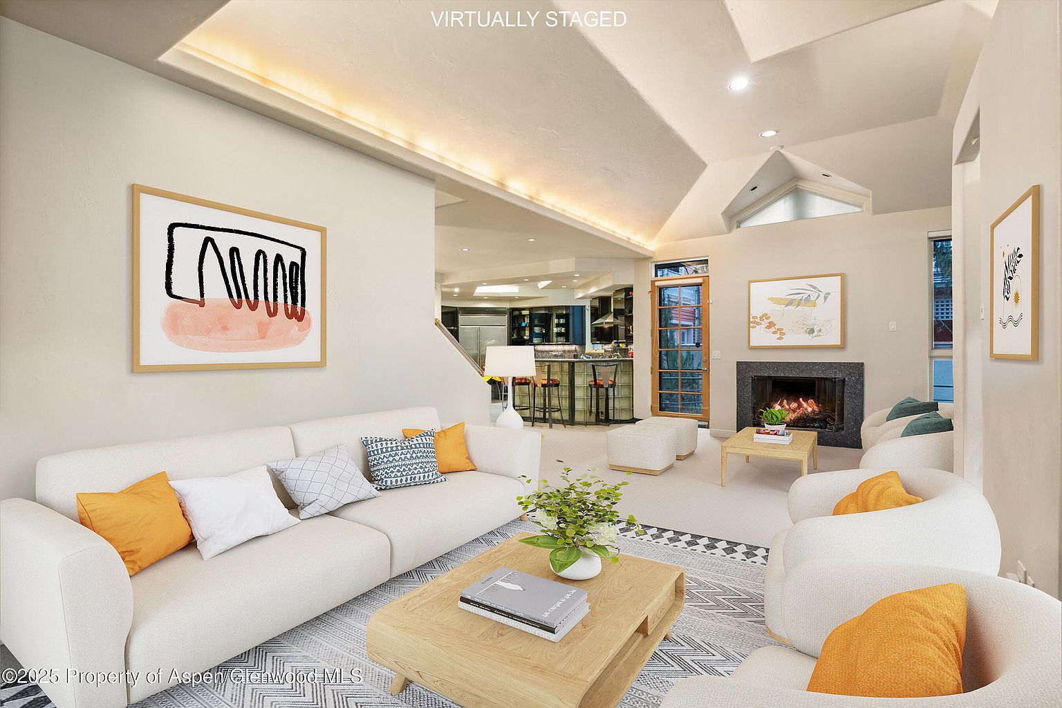 This is an interior shot of a living room, virtually staged, featuring a neutral color palette with pops of orange. The room includes a white sofa, two armchairs, a wooden coffee table, and artwork on the walls. A fireplace and open access to the kitchen area enhance the spacious feel, creating an inviting and modern living space.