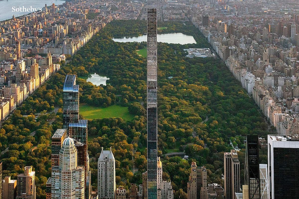 This high-altitude aerial perspective captures the iconic Central Park in New York City, dominated by the striking, ultra-slim silhouette of 111 West 57th Street. The image showcases the contrast between the lush, expansive greenery of the park and the dense, towering urban architecture of Manhattan. The cinematic composition emphasizes the building's extreme height and central location, offering a prestigious and unparalleled view of the city's most famous landmark.