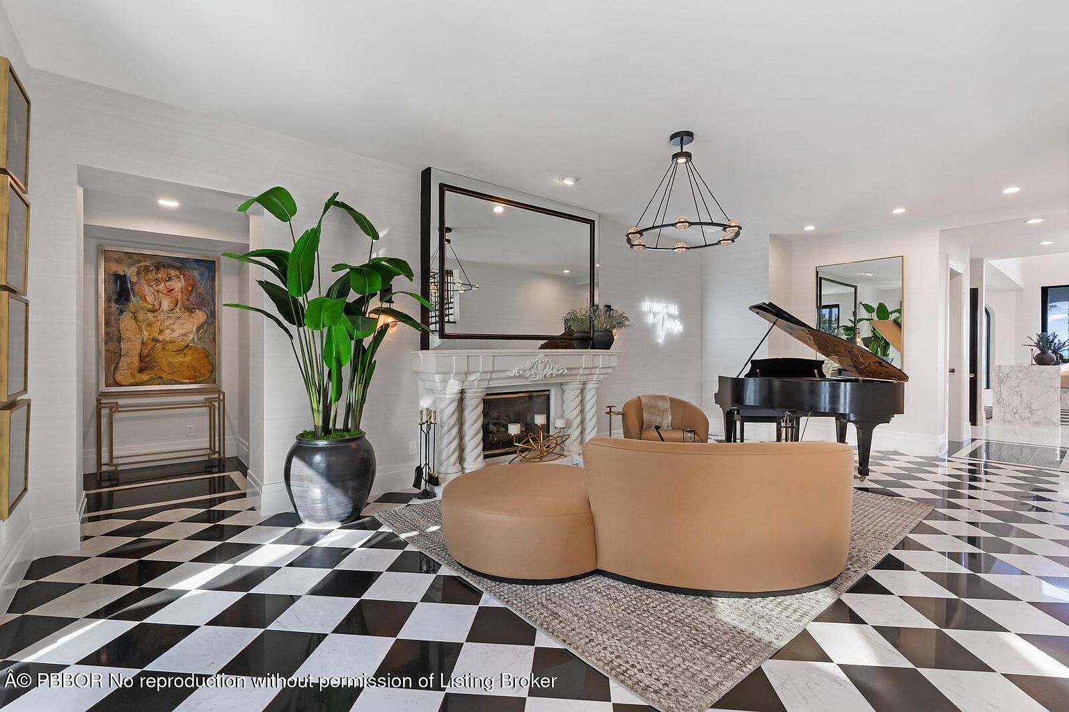 This interior shot showcases a luxurious living room with a striking black and white checkered floor. The room features a grand piano, a modern fireplace with a large mirror above, and stylish seating arrangements on a neutral-toned rug. A large potted plant and artwork add to the room's sophisticated ambiance.