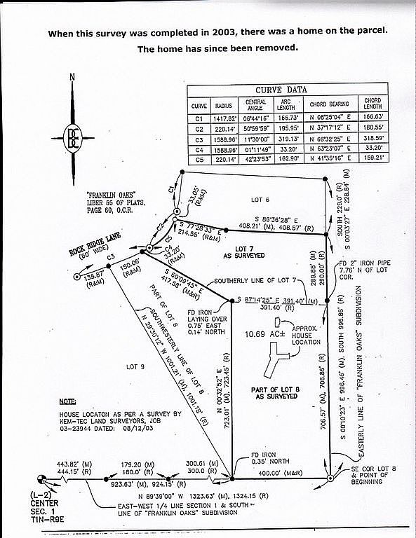 The image presents a detailed survey plat, likely used in real estate transactions to define property boundaries and features. It includes curve data, bearings, distances, and references to adjacent lots and subdivisions, providing a comprehensive overview of the parcel's dimensions and location. The plat also indicates the former location of a house on the property.