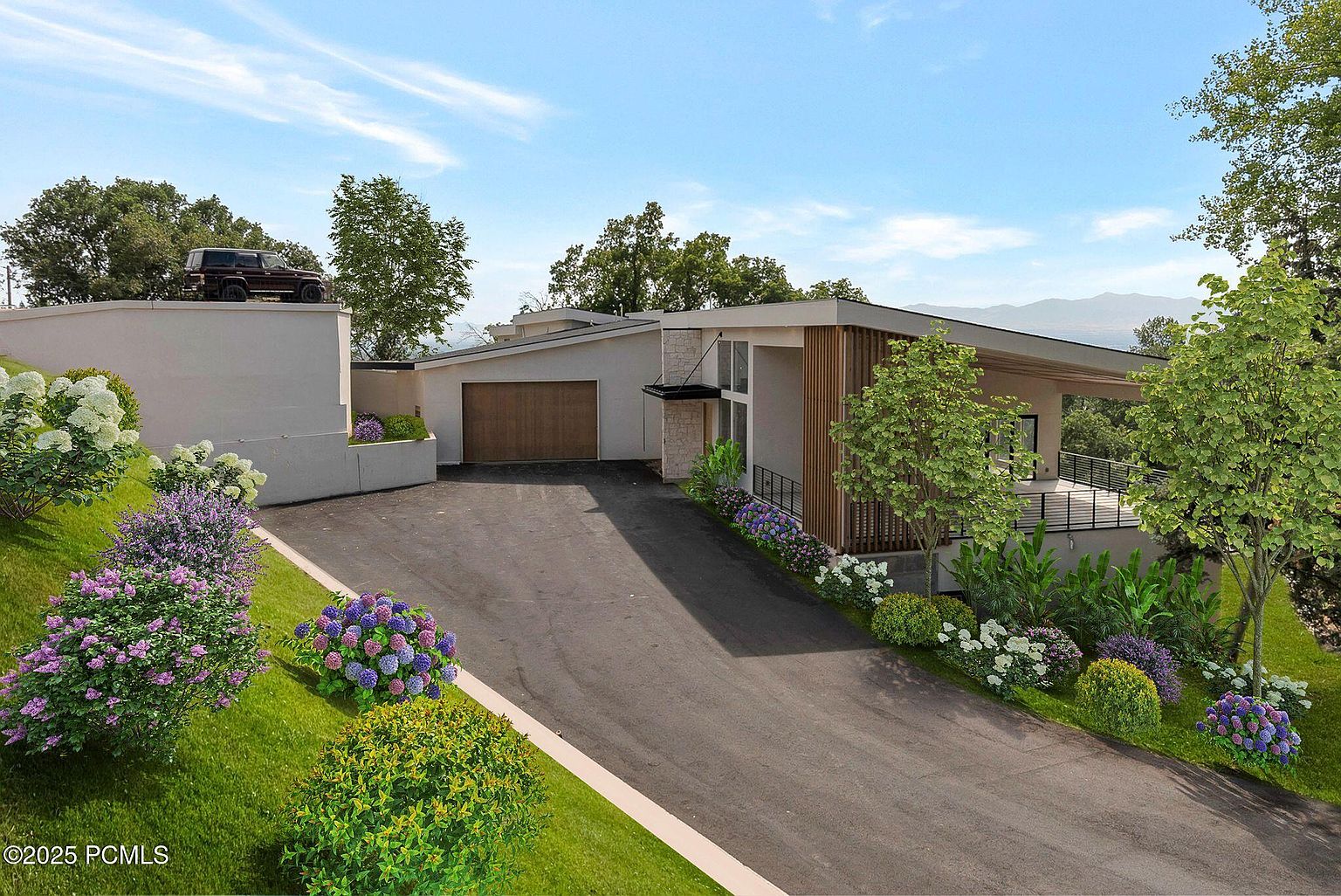 This image showcases the front exterior of a modern home with a sleek design. The property features a well-maintained driveway, a two-car garage, and professionally landscaped gardens with vibrant flowers and greenery. A unique architectural element includes a vehicle parked on an elevated section of the property, adding to the home's distinctive appeal.