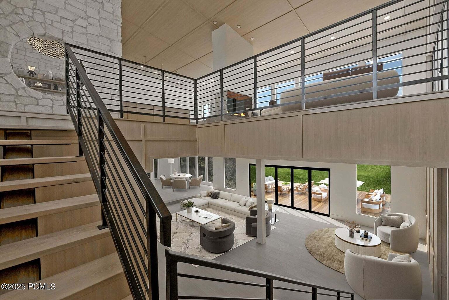 This is a view of a modern, open-concept living room from an elevated perspective, showcasing a spacious layout with multiple seating areas. The design features a blend of neutral tones, large windows offering natural light, and a contemporary staircase with metal railings. The room includes a dining area, a main living space with a sectional sofa, and an upper-level lounge area, all contributing to a luxurious and inviting atmosphere.