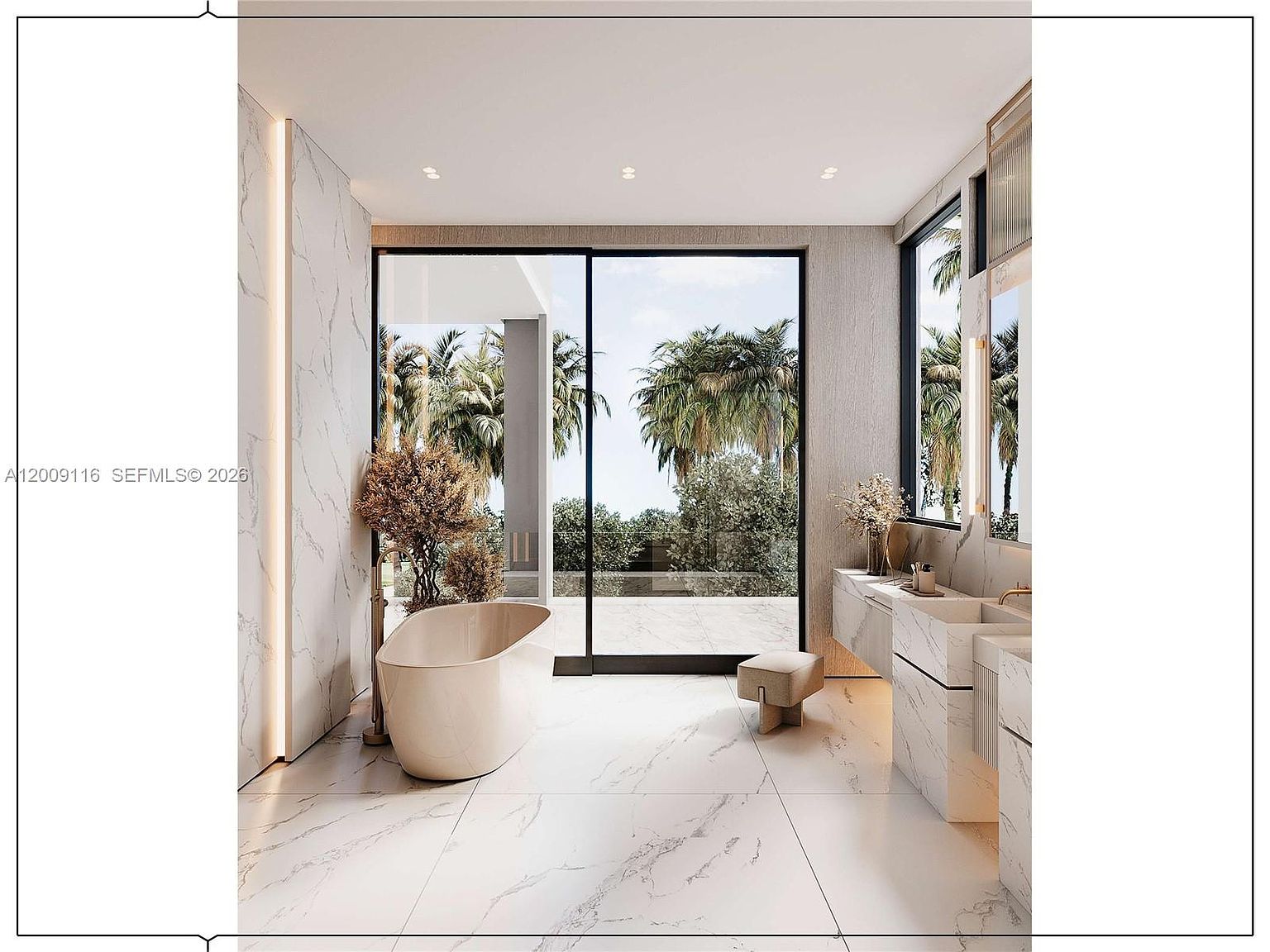 This luxurious primary bathroom features a freestanding soaking tub positioned next to a large glass sliding door that opens to a lush, tropical outdoor view. The space is finished with light-toned, veined stone surfaces on the walls and floors, complemented by a sleek, wall-mounted vanity with integrated sinks. A small, modern stool sits in the center, enhancing the minimalist and serene aesthetic of this high-end spa-like retreat.
