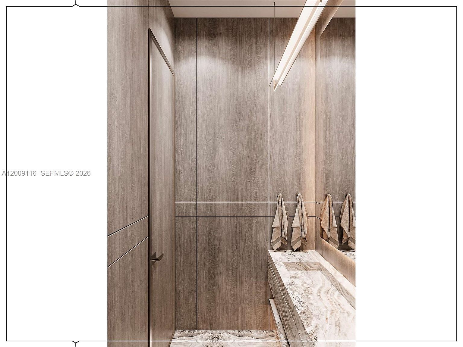 This modern powder room features sleek, light-toned wood paneling that covers the walls, creating a warm and cohesive aesthetic. A floating vanity topped with a patterned stone surface includes an integrated sink, complemented by a large mirror that enhances the sense of space. The room is illuminated by a linear light fixture, and towels are neatly hung on the wall, contributing to a minimalist and sophisticated atmosphere.