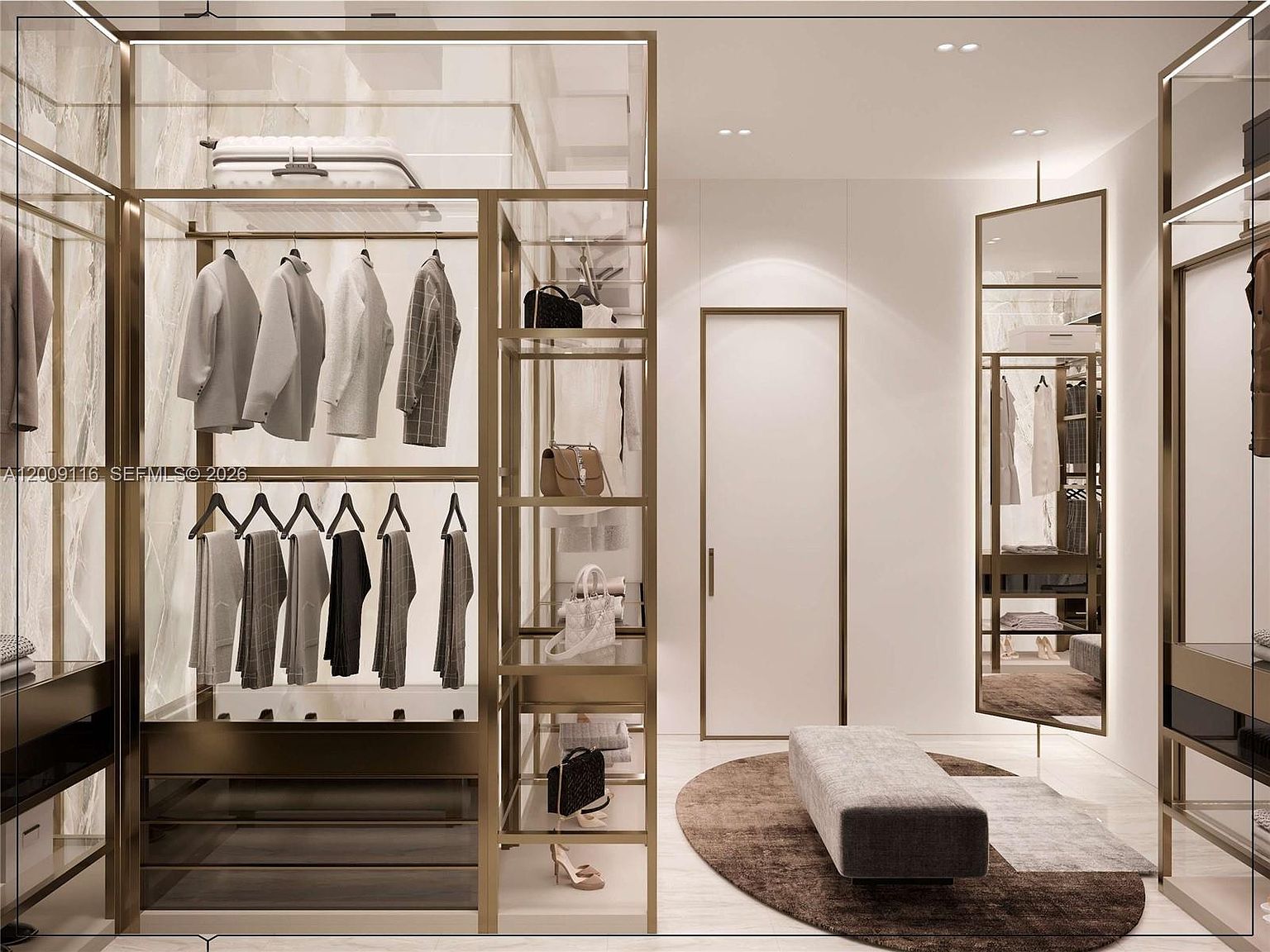 This sophisticated walk-in closet features a modern, open-concept design with gold-toned metal framing and glass shelving. The space includes a central bench atop a circular rug, a full-length mirror, and organized hanging storage for clothing and accessories. The clean, minimalist aesthetic is enhanced by integrated lighting and a neutral color palette, creating a luxurious and organized dressing area.