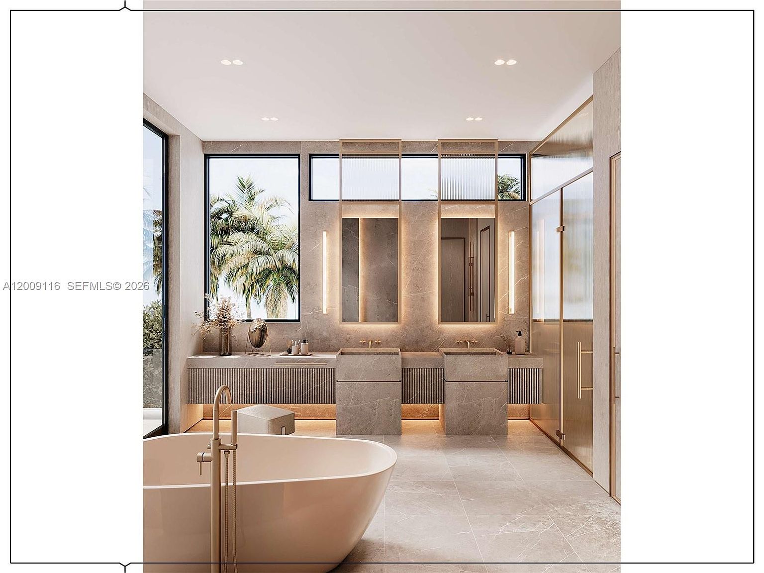 This luxurious primary bathroom features a double vanity with stone-clad sinks and integrated lighting, set against a backdrop of large-format stone wall tiles. A freestanding soaking tub sits in the foreground, complemented by gold-toned fixtures and a large window that brings in natural light. The space is designed with a modern, spa-like aesthetic, incorporating clean lines and a sophisticated neutral color palette.