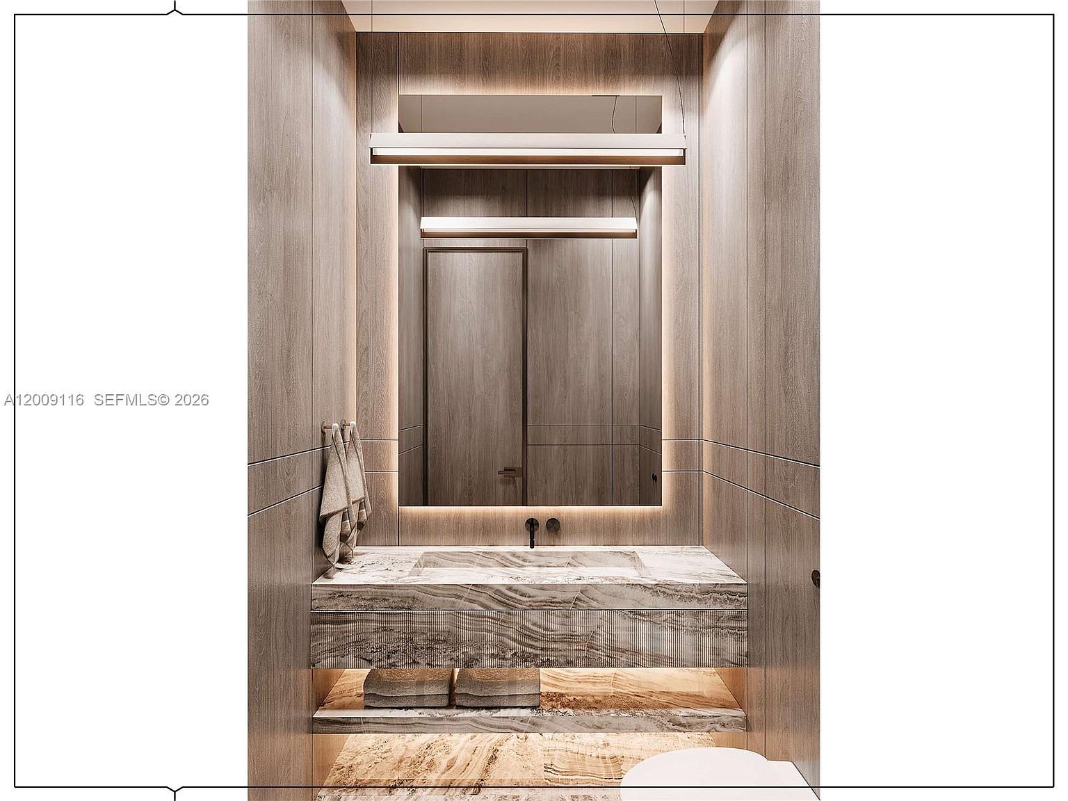 This modern powder room features a floating vanity with a stone countertop and integrated sink, complemented by warm, wood-paneled walls. A large, rectangular mirror is centered above the vanity, illuminated by sleek, linear light fixtures that create a sophisticated, spa-like atmosphere. The space is finished with a lower shelf for storage and soft, ambient under-cabinet lighting.