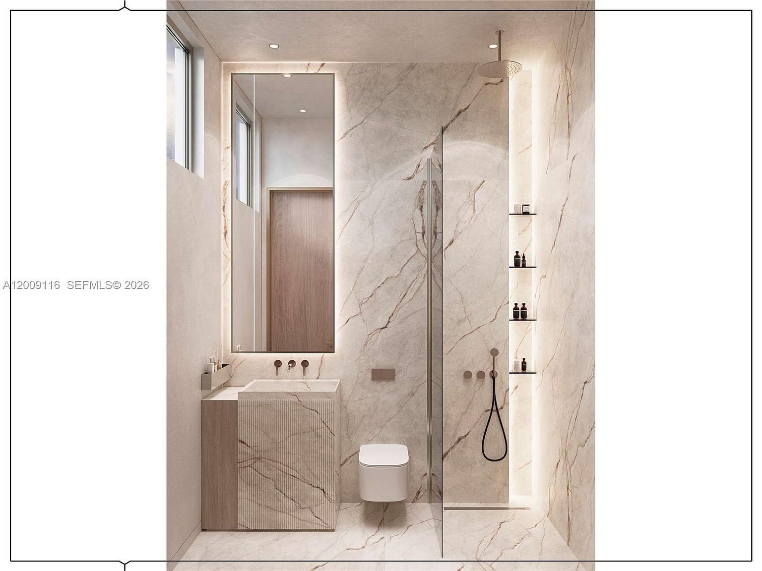This modern, minimalist bathroom features a sleek, stone-clad vanity and a wall-mounted toilet set against a backdrop of large-format, veined stone tiles. A tall, backlit mirror sits above the vanity, while a glass-enclosed shower area to the right includes integrated shelving and a rainfall showerhead. The space is illuminated by soft, ambient lighting, creating a sophisticated and serene atmosphere.