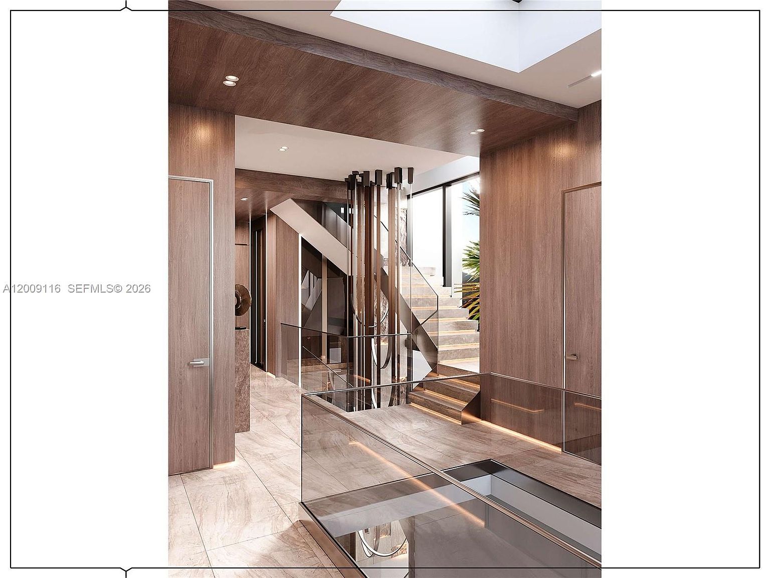 This sophisticated interior space features a dramatic staircase with glass railings and light wood treads, set against a backdrop of warm-toned wood paneling. A striking, vertical sculptural light fixture hangs centrally, drawing the eye upward toward a bright skylight. The polished stone flooring reflects the ambient light, creating a luxurious and modern atmosphere that emphasizes clean lines and high-end materials.
