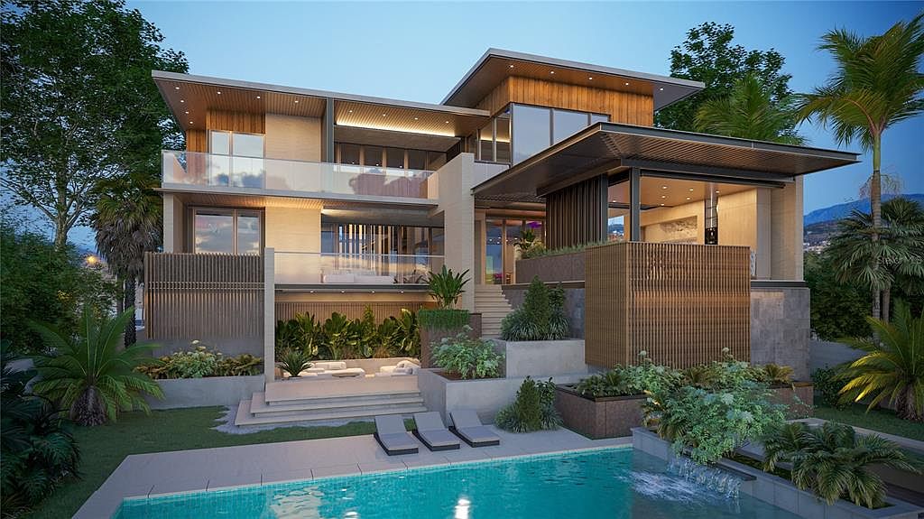 This image showcases a luxurious modern home with a stunning pool and spa area. The multi-level design of the house is complemented by lush landscaping, creating a serene and private outdoor oasis. The pool's clear water and the surrounding lounge chairs invite relaxation and entertainment.