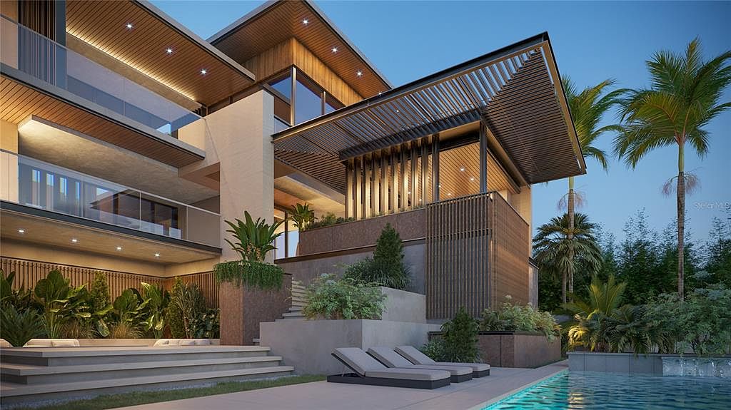 This is a rear exterior view of a modern luxury home, showcasing a multi-level design with a combination of wood, concrete, and glass elements. The property features a swimming pool, lounge chairs, and lush landscaping, creating a resort-like atmosphere. The architectural style emphasizes clean lines and open spaces, perfect for indoor-outdoor living.
