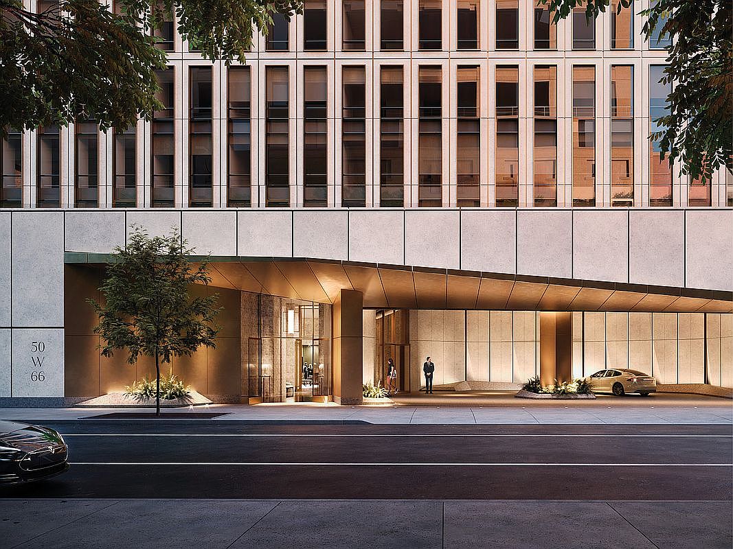 This sophisticated, modern building entrance features a dramatic, angular bronze-toned canopy that extends over a sleek driveway. The facade is composed of clean, light-colored stone panels and floor-to-ceiling windows, with a prominent '50 W 66' address sign displayed on the left. A doorman stands near the entrance, while a luxury car is parked under the canopy, creating an atmosphere of high-end urban elegance.