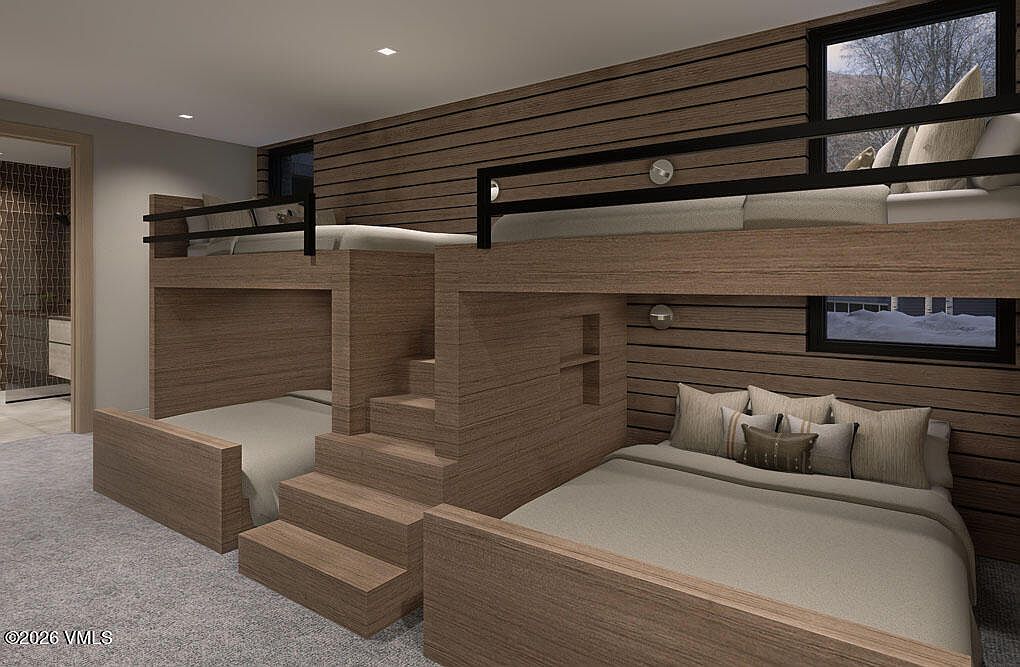 This is a bedroom featuring built-in bunk beds with a modern, rustic design. The beds are constructed from wood with a horizontal plank design on the walls behind them. The room has a cozy and inviting atmosphere, perfect for a children's room or guest bedroom in a mountain retreat.