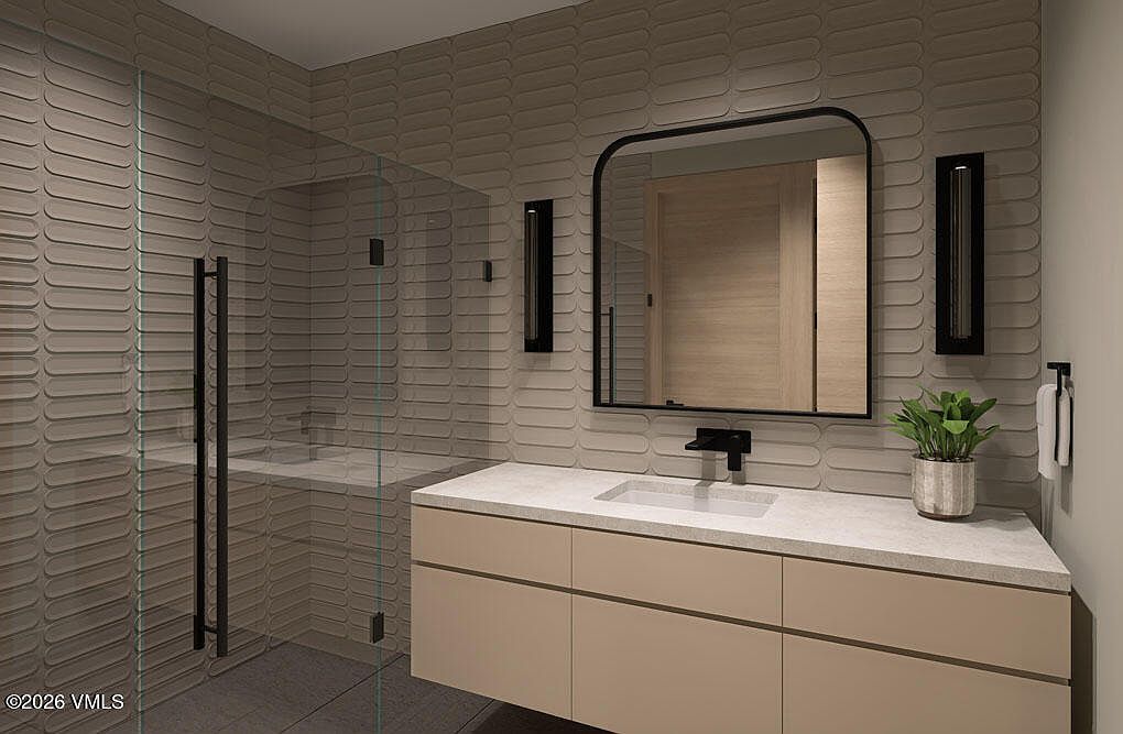 This is a modern primary bathroom featuring a floating vanity with a light beige finish and a white countertop. A sleek, black-framed mirror hangs above the sink, complemented by contemporary black sconces. The shower is enclosed with glass, and the walls are adorned with textured, horizontally-oriented tiles, creating a spa-like atmosphere.