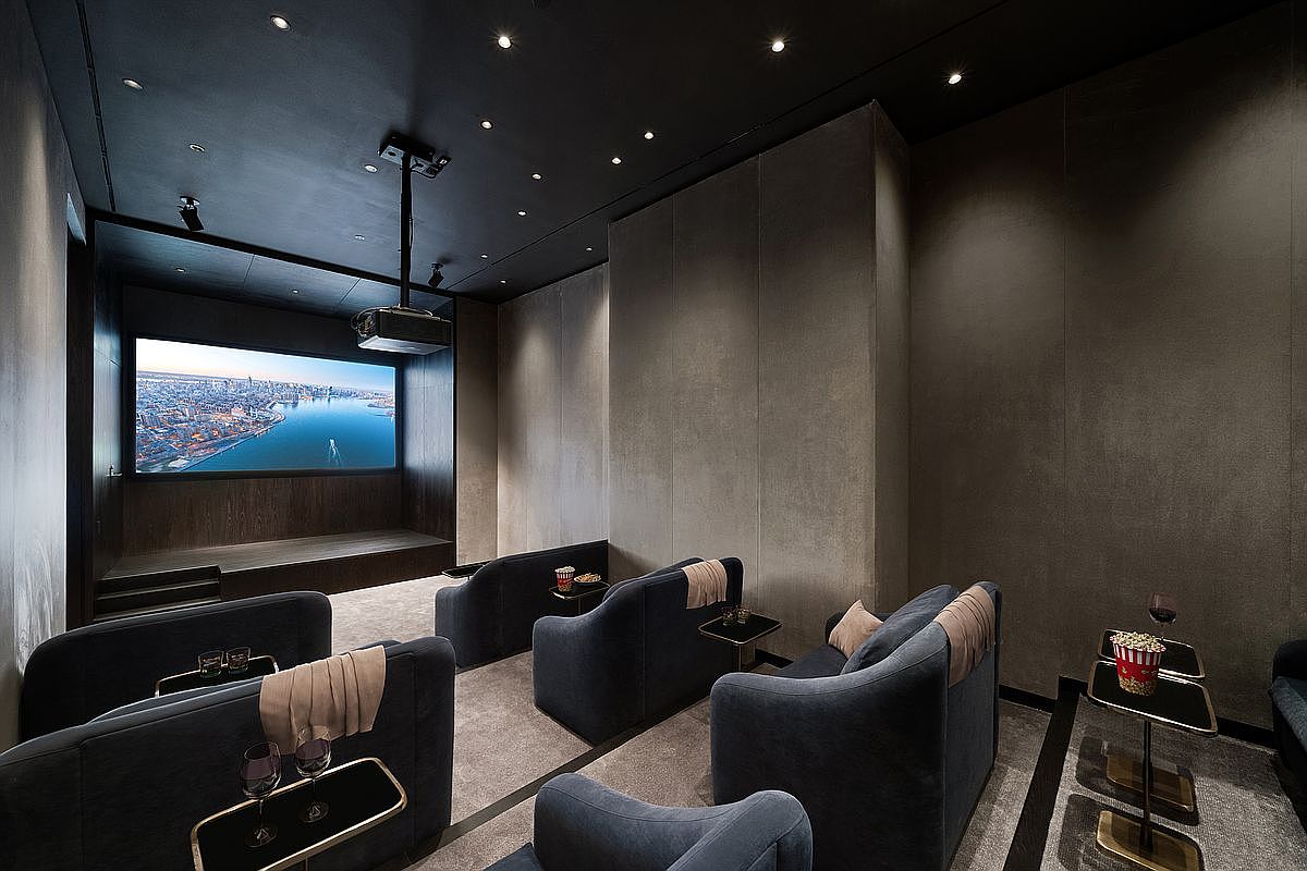 This image showcases a sophisticated, modern home theater designed for an immersive cinematic experience. The room features tiered seating with plush, dark blue armchairs, each equipped with a small side table for refreshments, set against a backdrop of dark, textured walls and a minimalist ceiling with recessed lighting. A large projector screen displays a vibrant cityscape, creating a luxurious and private entertainment space perfect for high-end residential living.