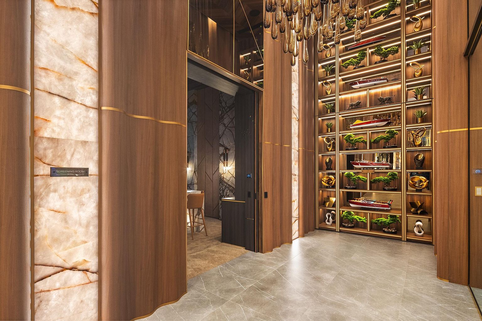 This sophisticated hallway features a striking combination of warm wood paneling and illuminated stone accents, creating a luxurious and modern atmosphere. A tall, multi-tiered shelving unit displays decorative model boats and greenery, while a dramatic chandelier hangs from above to provide elegant lighting. The perspective looks down a polished stone-tiled corridor toward a doorway leading into a dimly lit room, emphasizing the high-end architectural design.