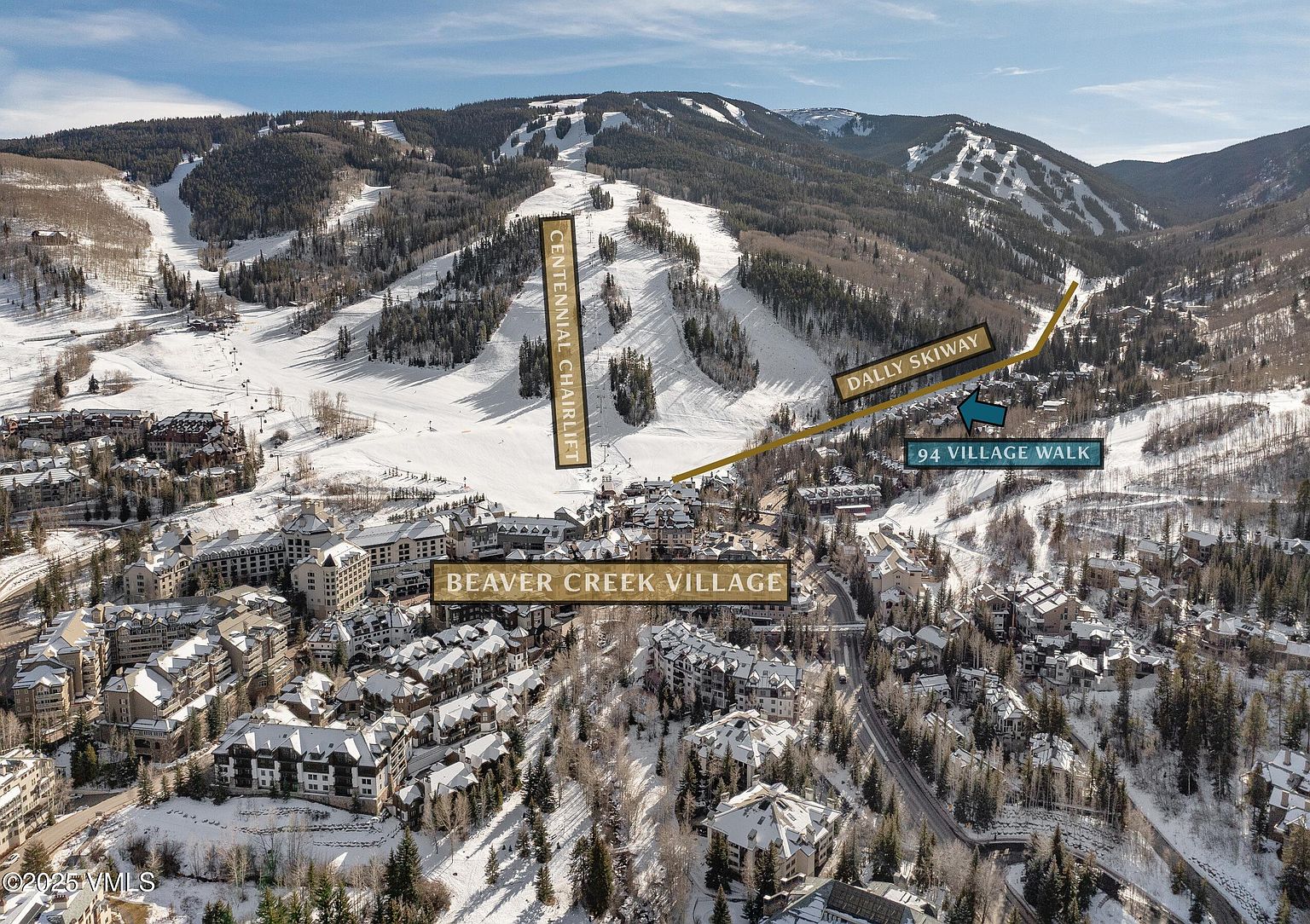 This aerial view showcases a luxurious ski resort village nestled in a snow-covered mountain landscape. The scene features well-maintained ski slopes, charming chalet-style buildings, and convenient access to ski lifts, highlighting the property's prime location and recreational opportunities. The overall impression is one of upscale mountain living and winter sports paradise.