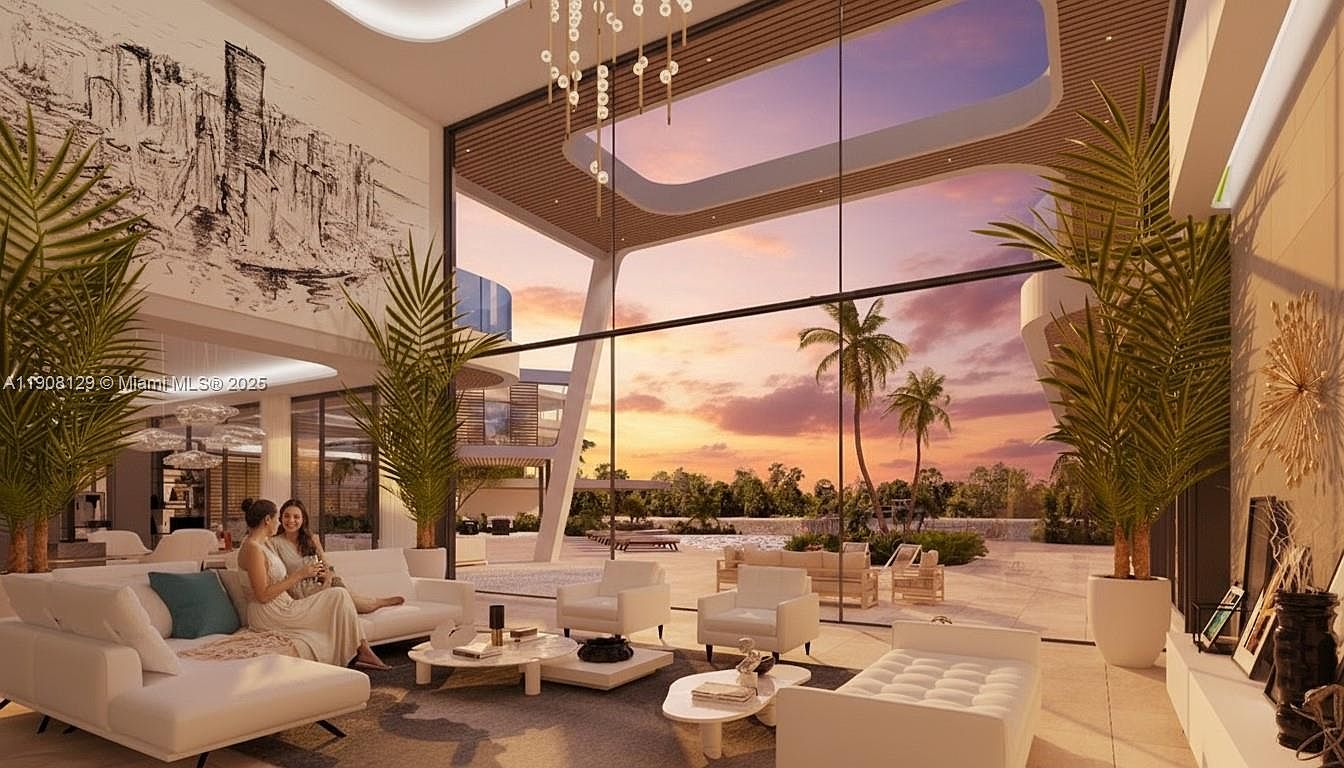 This is a luxurious living room with floor-to-ceiling windows offering a stunning view of the sunset and palm trees. The room is furnished with modern white sofas and armchairs, complemented by stylish coffee tables and decorative plants. The overall impression is one of elegance and tranquility, perfect for relaxation and entertaining.
