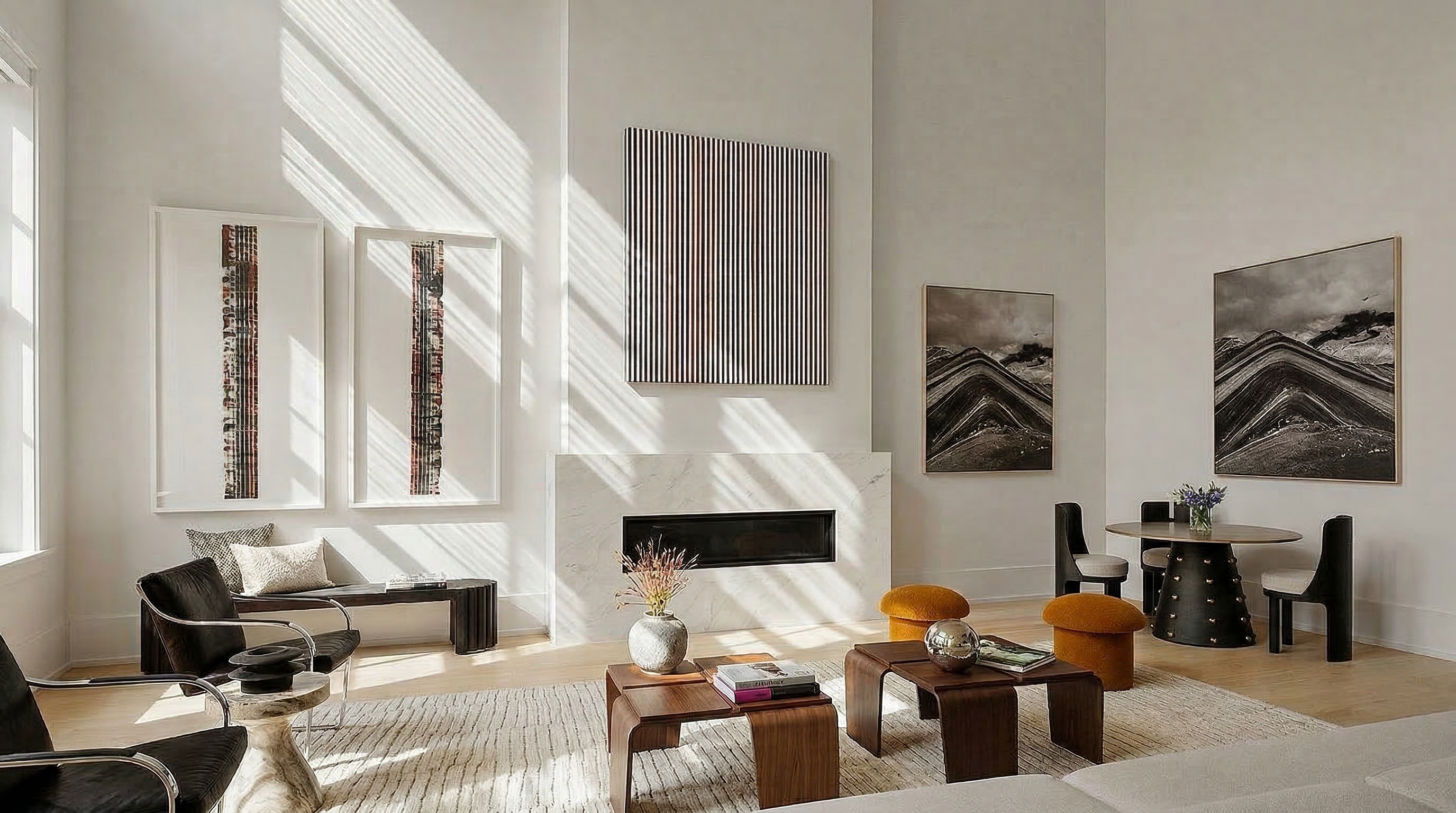 This sophisticated, contemporary living room features a striking fireplace with marble cladding and high ceilings that enhance the airy, open feel. The space is anchored by a large, neutral-toned rug, mid-century modern wood coffee tables, and artistic, gallery-style decor that creates a polished, upscale aesthetic. Large, light-filled windows filtered with sunlight add warmth to the minimalist yet thoughtfully curated interior.