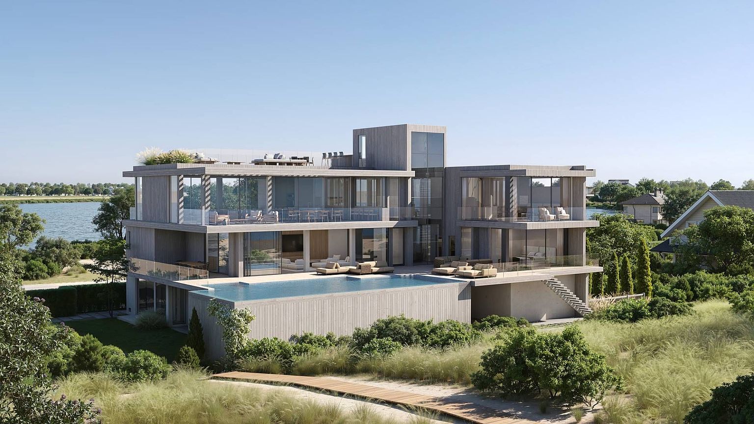 This modern, multi-level luxury residence features a striking contemporary design with extensive glass walls and light-toned wood siding. The home boasts a prominent infinity-edge pool on the main deck, overlooking a serene lake, with a rooftop terrace and multiple outdoor seating areas. The perspective is an elevated, cinematic exterior shot that highlights the seamless integration between the architectural structure and the surrounding natural landscape.