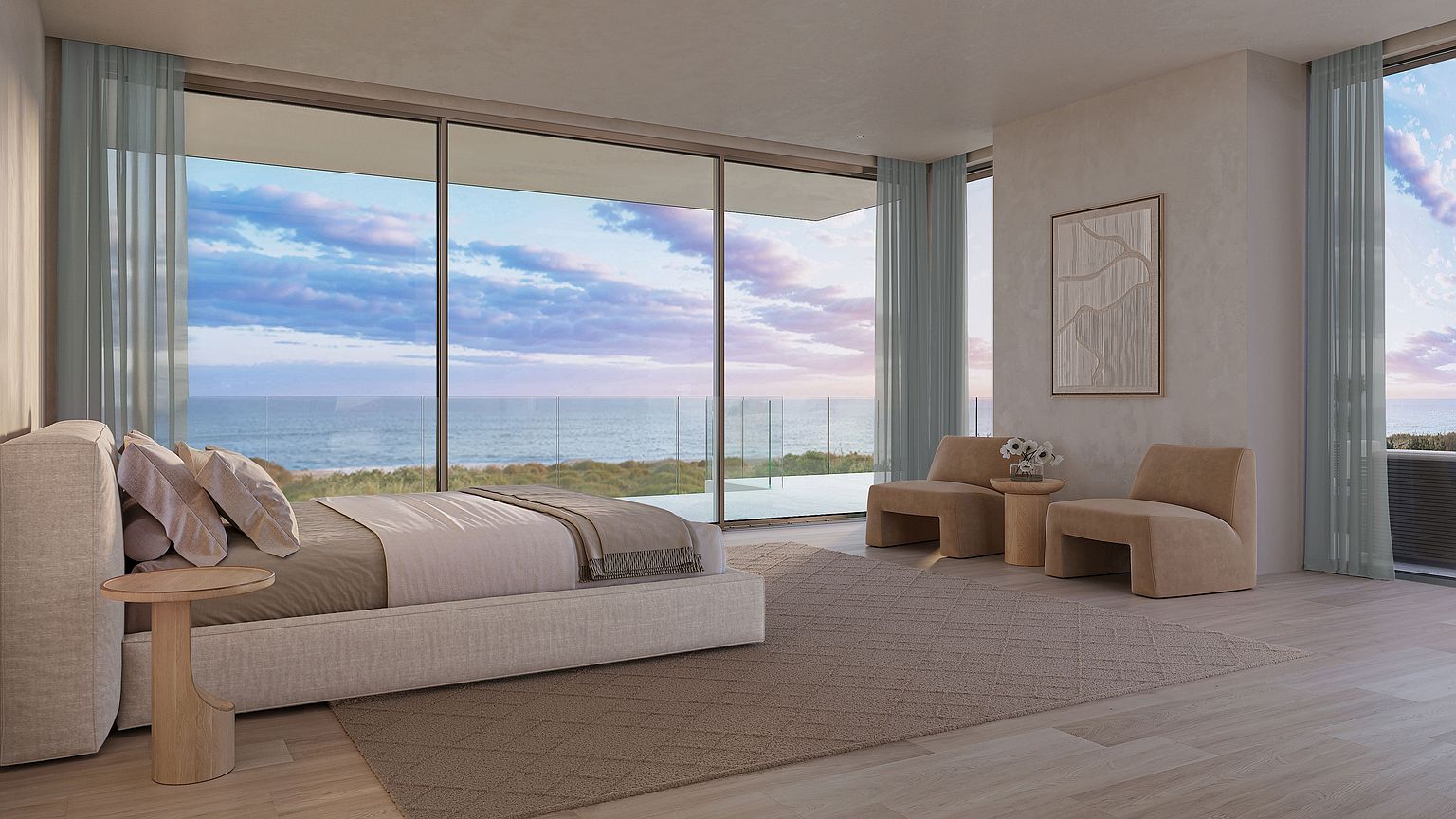 This serene primary bedroom features a minimalist aesthetic with a neutral color palette and light wood flooring. The room is anchored by a large bed and two modern lounge chairs, all positioned to take advantage of the expansive floor-to-ceiling windows that offer panoramic ocean views. A textured piece of wall art and simple side tables complete the sophisticated, tranquil atmosphere of this coastal retreat.