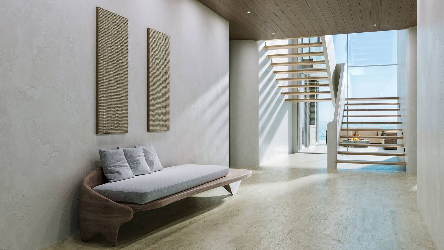 This sophisticated entryway features a sculptural wooden bench with light gray cushions set against a textured wall adorned with two vertical art pieces. A striking open-tread staircase with a minimalist design leads to an upper level, while large windows at the rear provide a bright, airy view of the outdoors. The space is finished with light-toned stone flooring and a warm wood-paneled ceiling, creating a serene and modern atmosphere.