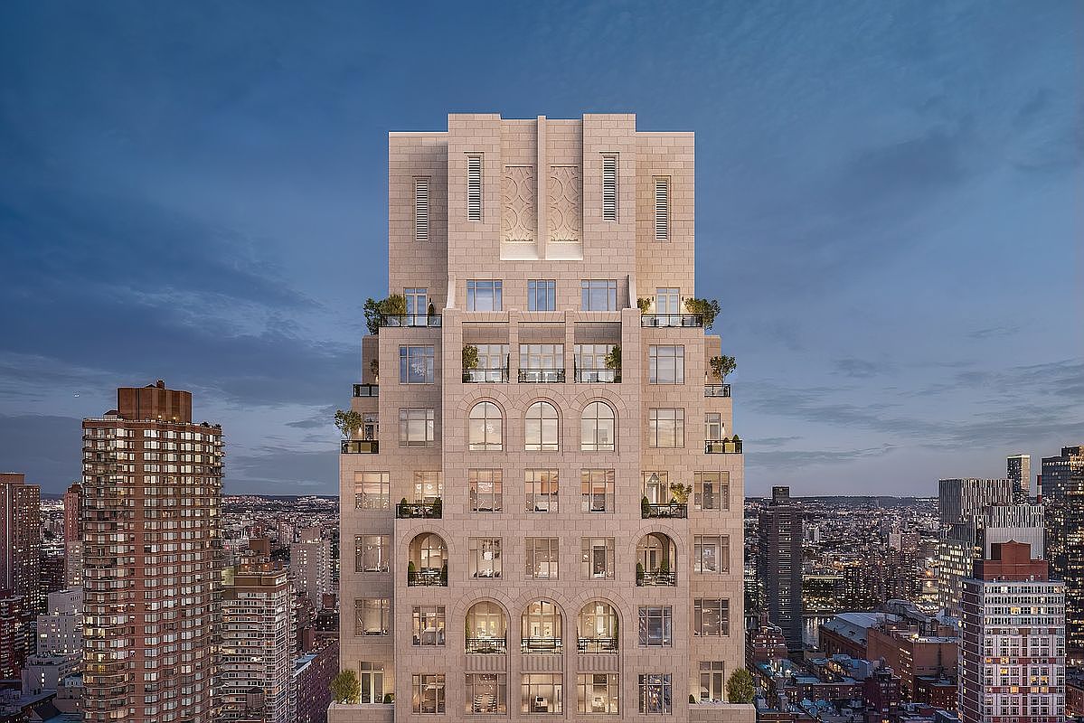 This cinematic aerial shot captures the majestic facade of a high-rise luxury residential building at twilight, showcasing its intricate stone masonry and classic architectural detailing. The building features a tiered design with multiple balconies, arched windows, and a prominent central crown, standing out against the sprawling urban cityscape. The perspective emphasizes the building's grandeur and its commanding presence within the dense metropolitan skyline.