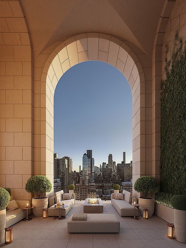This luxurious, high-rise terrace features a grand stone archway framing a breathtaking panoramic view of the city skyline. The space is elegantly furnished with plush, neutral-toned outdoor sofas, a central fire pit, and manicured topiary trees, creating a sophisticated and serene urban oasis. The warm, ambient lighting and clean architectural lines evoke a sense of exclusive, high-end living.