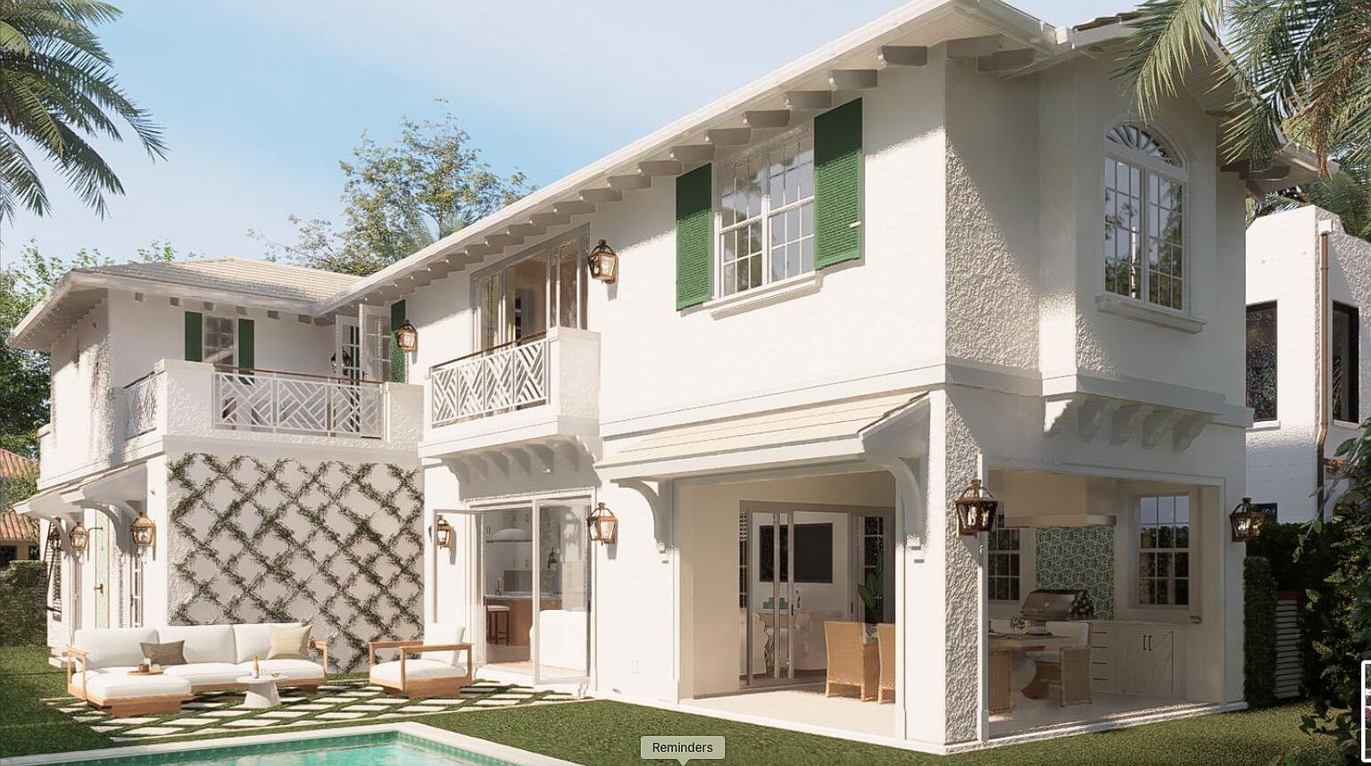 This image showcases the rear exterior of a luxurious two-story home with a Mediterranean-inspired design. The property features a well-manicured lawn, a swimming pool, and multiple outdoor living spaces, including a covered patio and a balcony. The white stucco facade, green shutters, and decorative architectural details contribute to the home's elegant and inviting appeal, perfect for outdoor entertaining and relaxation.