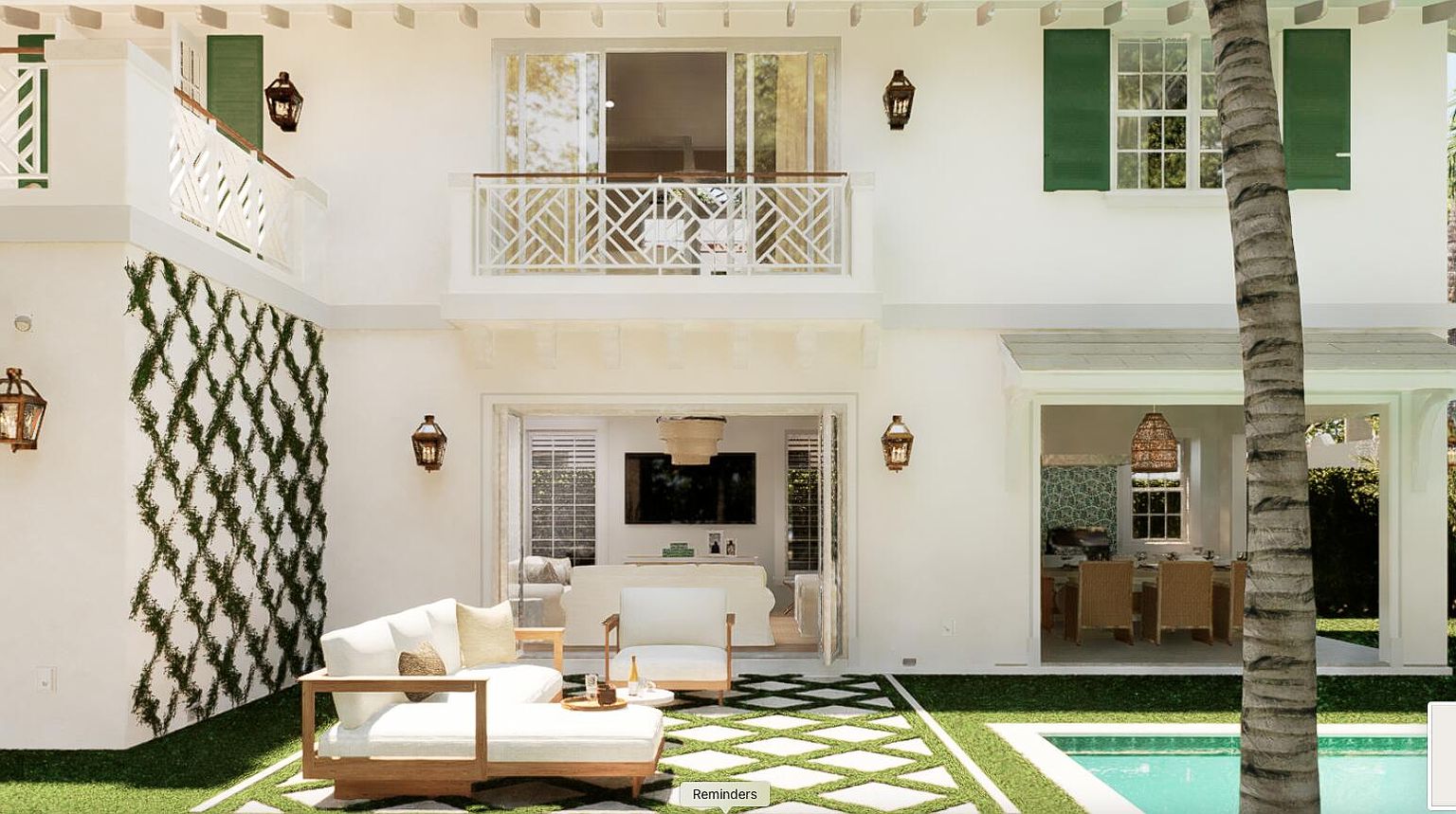 This image showcases the rear exterior of a luxurious home, featuring a well-manicured patio area with stylish outdoor furniture, a swimming pool, and lush greenery. The architectural design includes a balcony, large windows, and elegant lighting fixtures, creating an inviting and sophisticated outdoor living space. The overall impression is one of relaxation and upscale living.