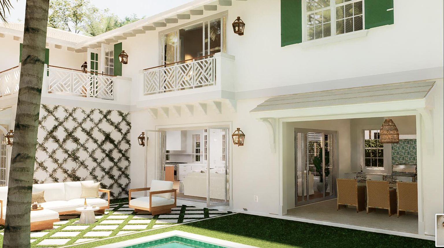 This is a rear view of a luxurious two-story house featuring a white exterior with green shutters and decorative balconies. The outdoor space includes a patio with a white sofa and chairs, a small pool, and a dining area visible through a large opening. The overall impression is one of elegant outdoor living and relaxation.