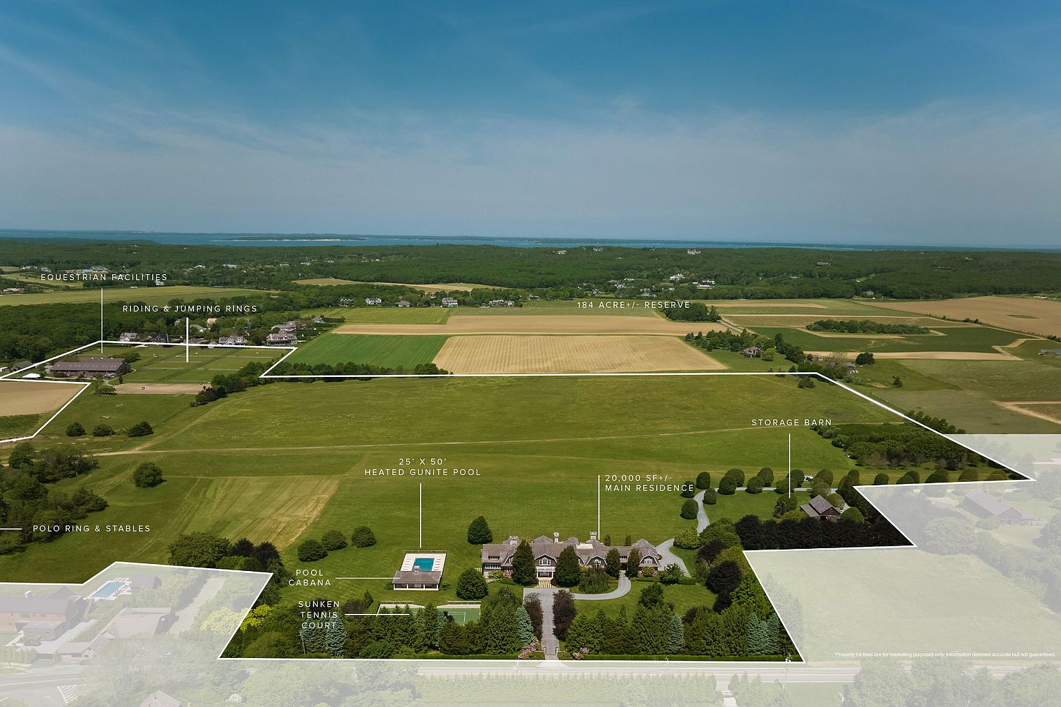 This aerial view showcases an expansive estate featuring equestrian facilities, riding rings, polo ring and stables, and a 184-acre reserve. The property includes a 20,000 sqft main residence, a 25' x 50' heated gunite pool with a pool cabana, and a sunken tennis court. The overall impression is one of luxury, privacy, and extensive recreational amenities.