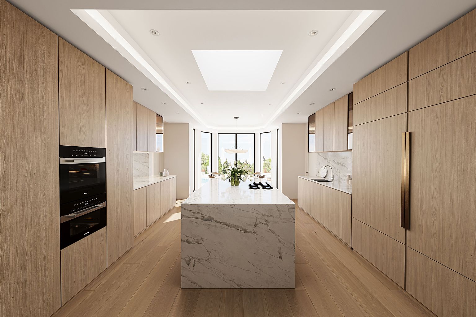 This is a bright and modern kitchen featuring light wood cabinetry and a large marble island. The kitchen is well-lit with natural light from a skylight and large windows at the end of the room. The overall impression is clean, spacious, and luxurious, perfect for a high-end real estate listing.
