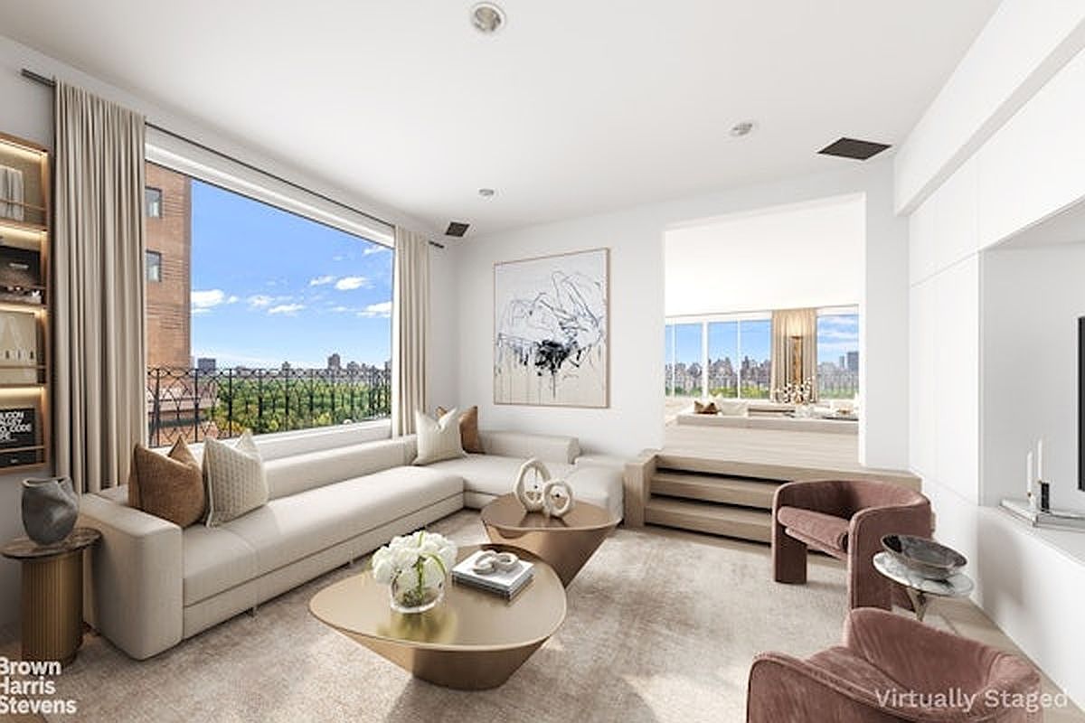 This sophisticated living room features a large, light-colored sectional sofa and two plush, mauve-toned armchairs arranged around sculptural gold coffee tables. A raised platform area in the background offers an additional seating space, while large windows provide expansive views of the city skyline and greenery. The room is decorated with a large abstract painting and neutral-toned area rug, creating a bright, airy, and luxurious atmosphere.