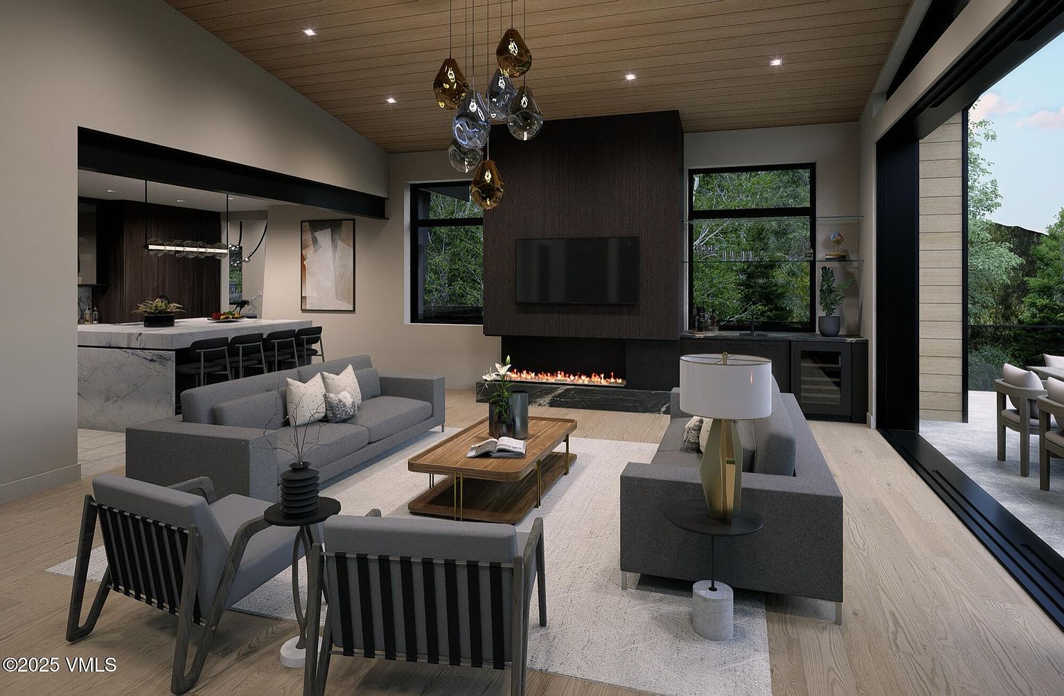 This is a modern living room featuring a sleek fireplace with a dark accent wall, two gray sofas, and two armchairs. The room has a contemporary design with a wooden ceiling and large windows that offer a view of the outdoors. The open floor plan connects to the kitchen area, creating a spacious and inviting atmosphere.